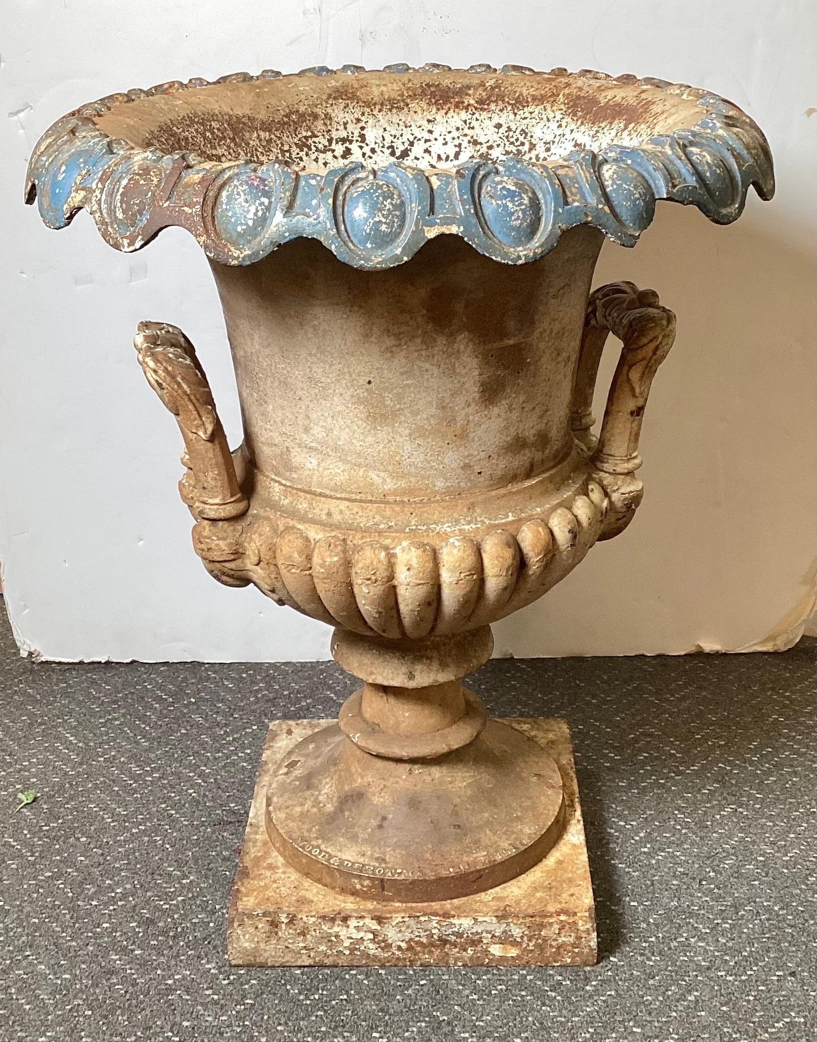 A Mid-19th century cast iron cold painted garden urn. Made by wood and Perot with a mark dating this to PRE 1865. A famous maker from Philadelphia of excellent made iron garden ornaments. The surface with old worn paint and surface oxidation. There