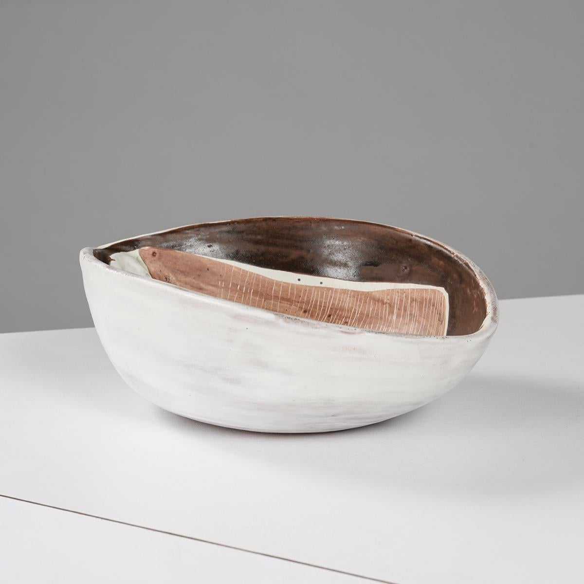 Large bowl cup by Mado Jolain, French ceramist active from 1946 to 1970, with remarkable work of textures, simple and strict shapes and thick and shiny enamels which give her artworks great modernity.

Slightly oval, the cup is animated by a
