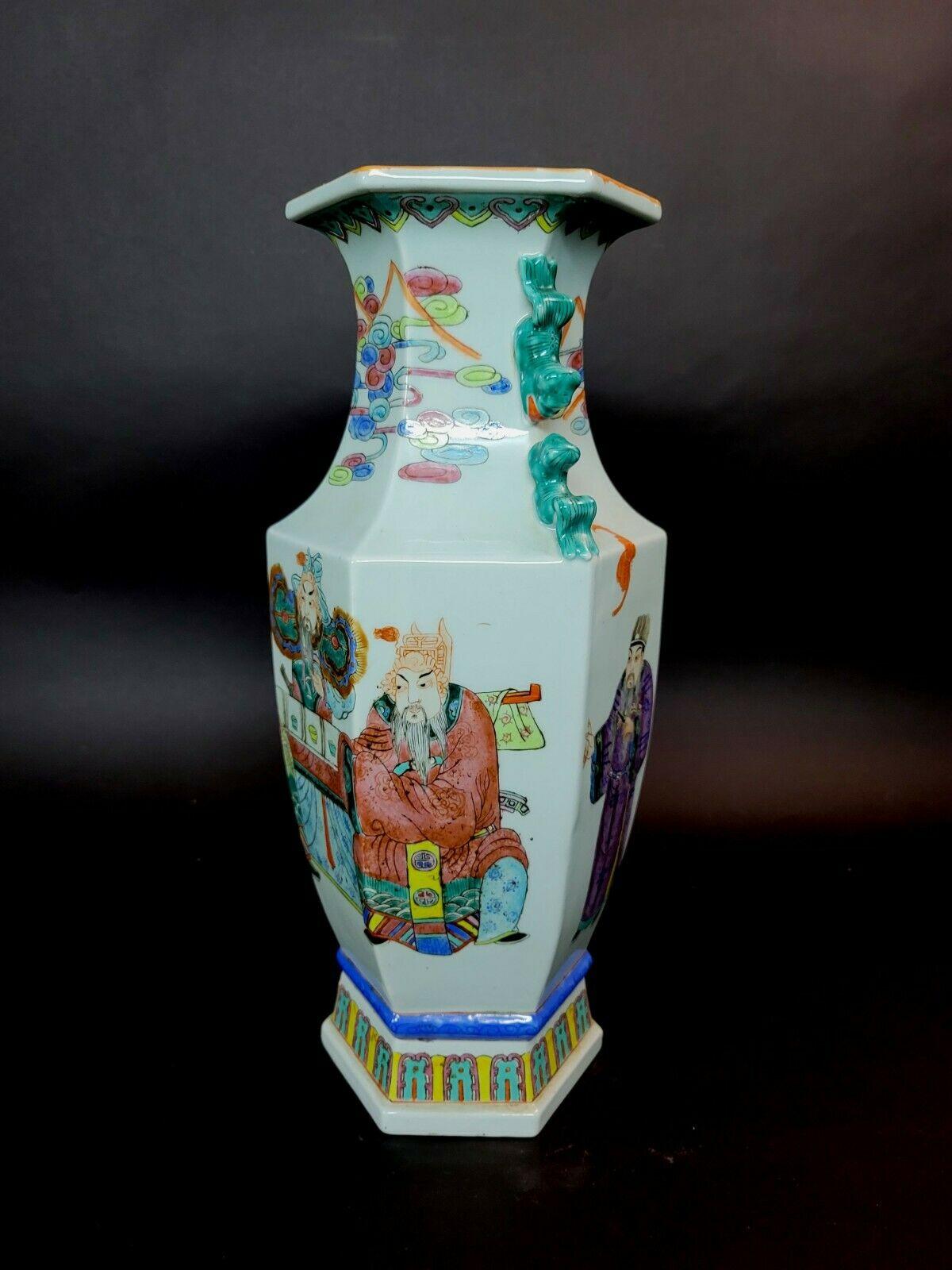 An emperor is commanding his attendants. The neck has foo dog handles and swirling multicolor clouds. Orange bats fly on the back of the vase.



 
