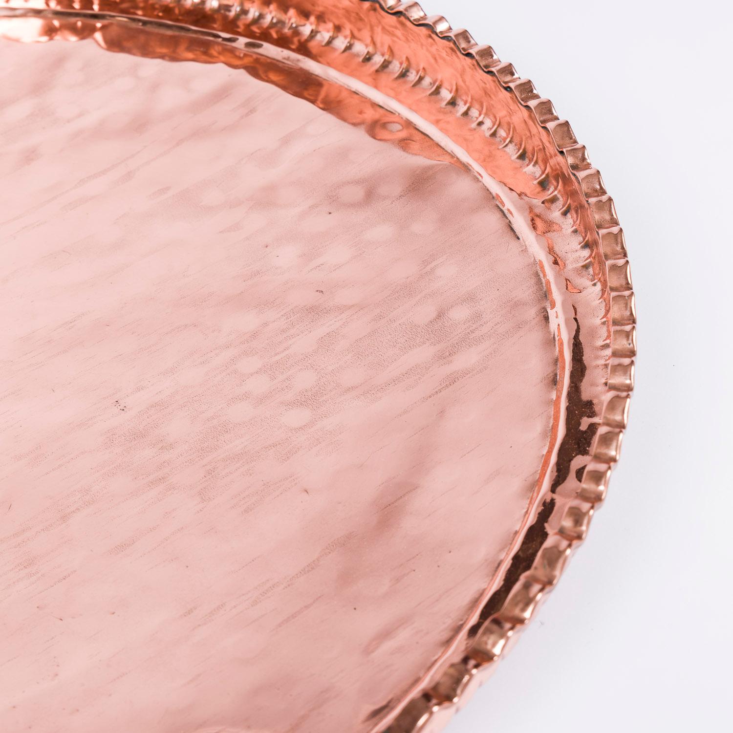 A large late 19th century circular copper tray with pie crust edge.