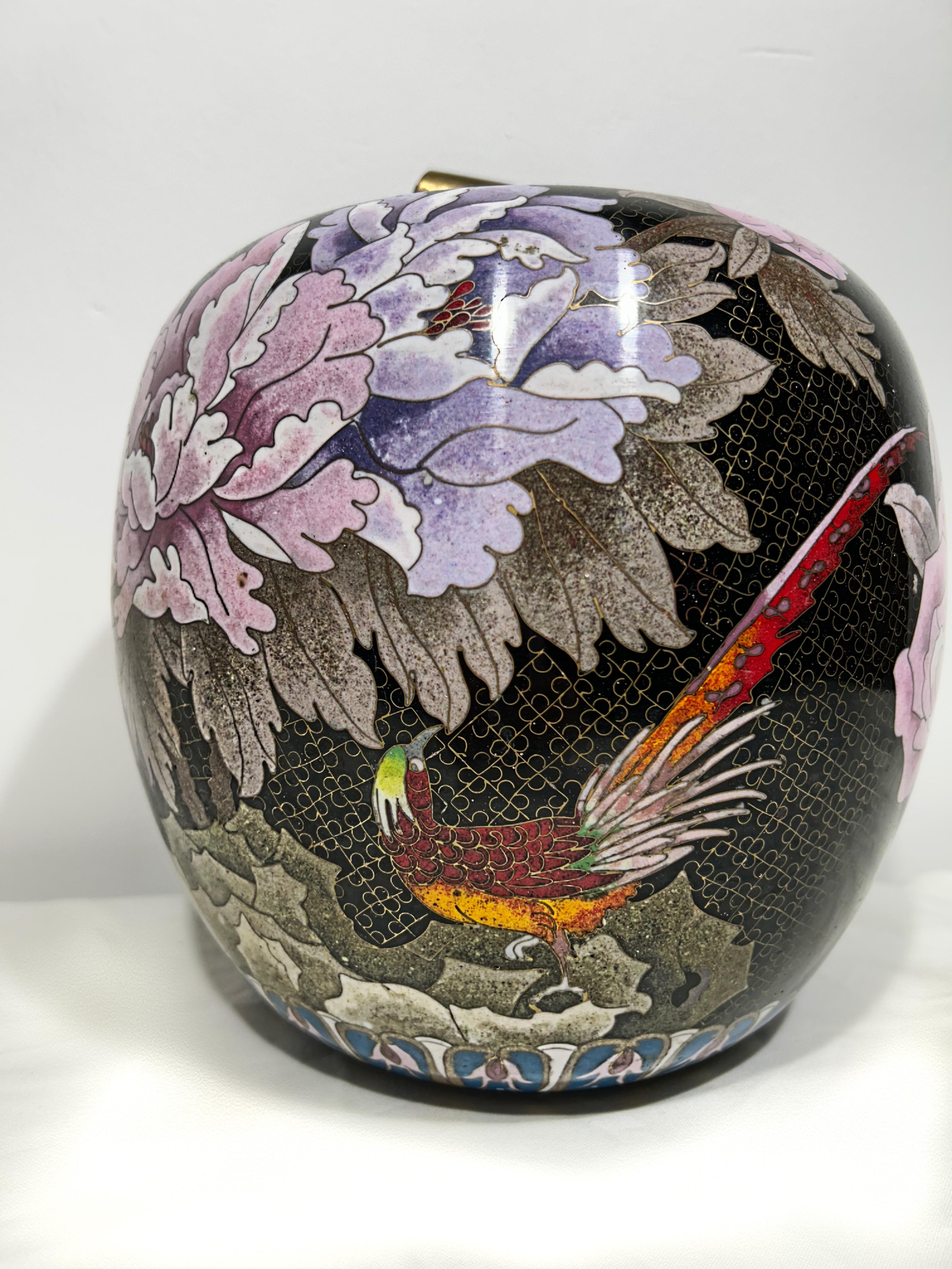 A Chinese black enamel cloisonné and brass ginger jar, with chrysanthemum flowers, dog wood flowers , butterflies and beautiful parrots , rich in colours . handcrafted on solid brass.