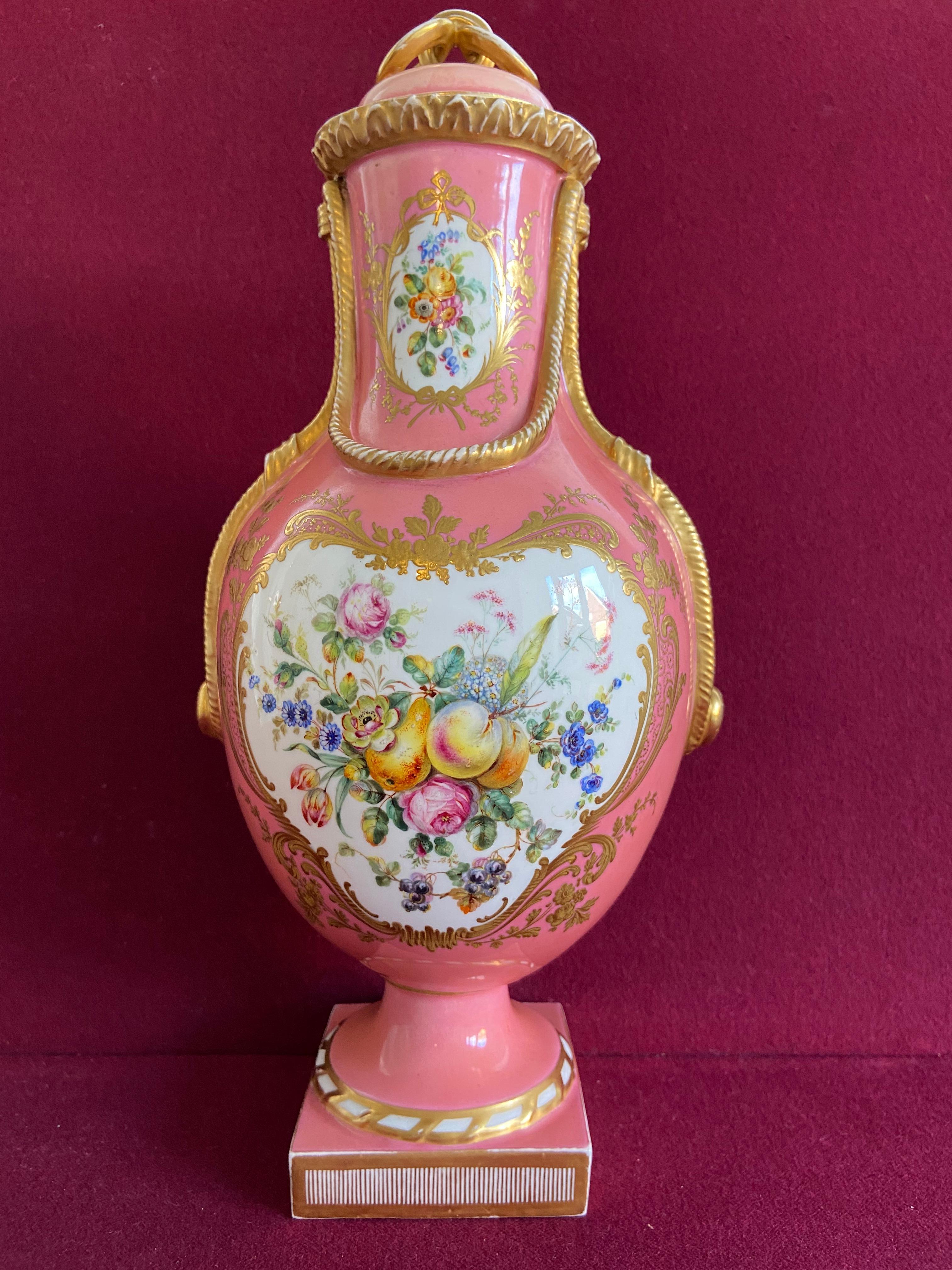 A large Coalport 'Coalbrookdale' porcelain vase c.1855. Decorated with finely painted panels of fruit and flowers by William Cook, reserved on a  'Rose du Barry' ground within elaborate raised and tooled gilt borders. The ‘Rose du Barry’ or ‘Rose du