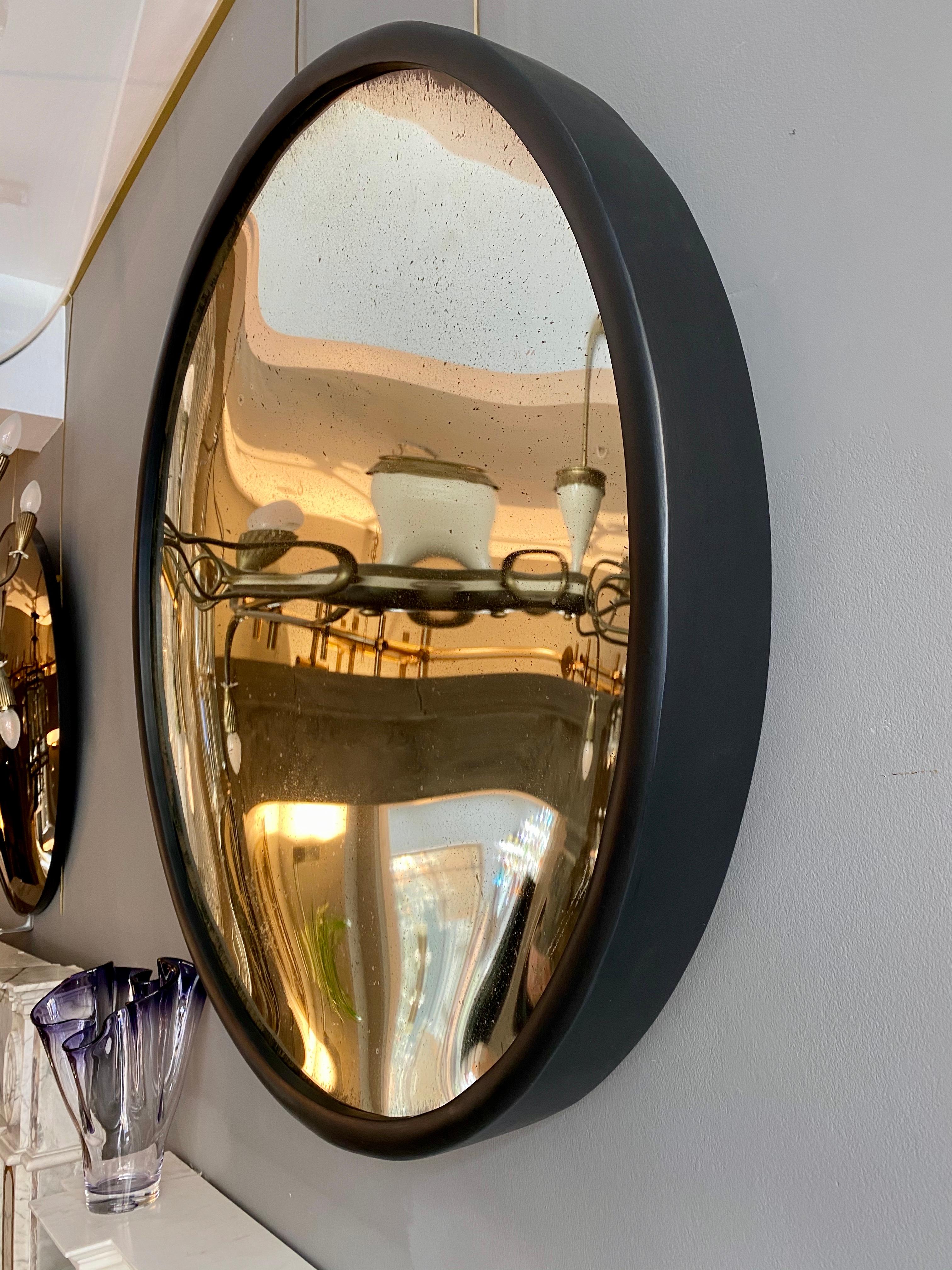 A large contemporary concave mirror with distressed silver plate within a thick ebonized frame. Handmade in the UK 

Frame 10cm thick.