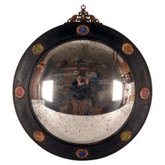 Un grande specchio convesso, cornice in legno, bronzo, pietre. Italia, inizio del XIX secolo.