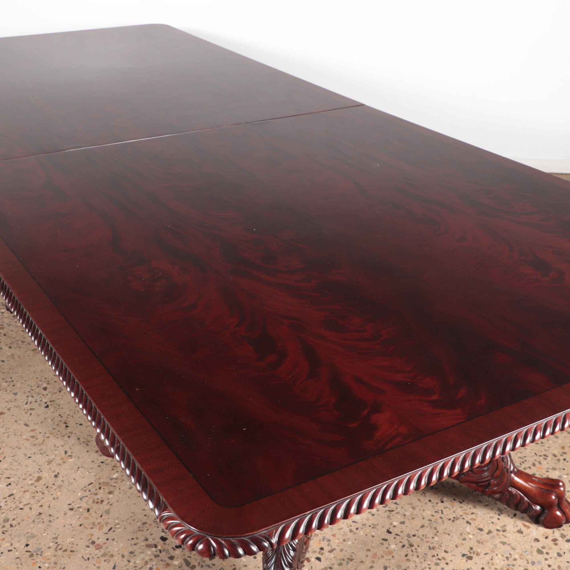 A large crotch mahogany double pedestal console/dining room table. with gadroon/rope carved edge. C 1950.