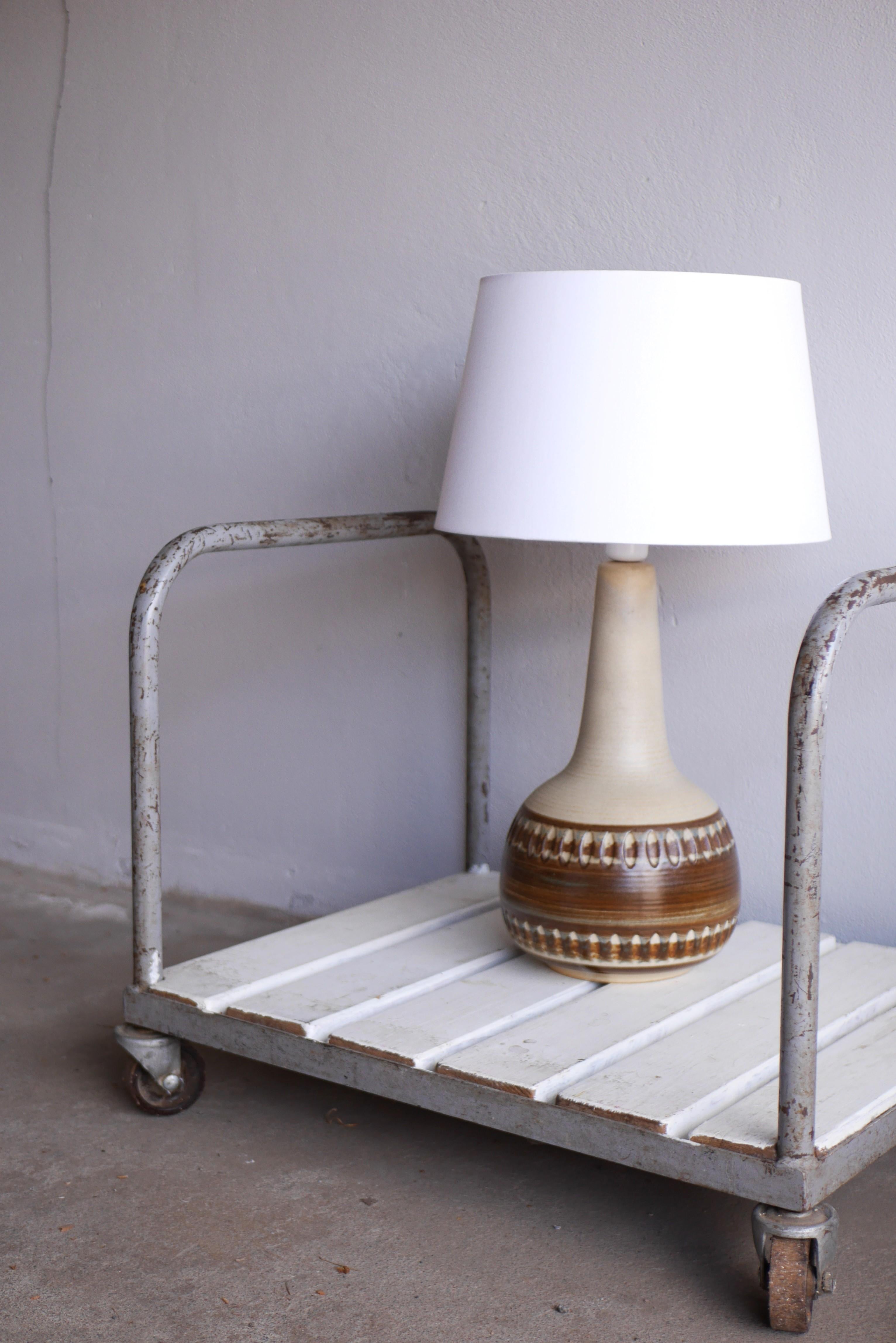 A very large handmade ceramic stoneware lamp base made by Söholm, Stentöj, Denmark. This lamp will make a statement and it is a classic and timeless lamp, it has a pale beige and a wamr brown colour with speckled harpsichord glazing at the base in a