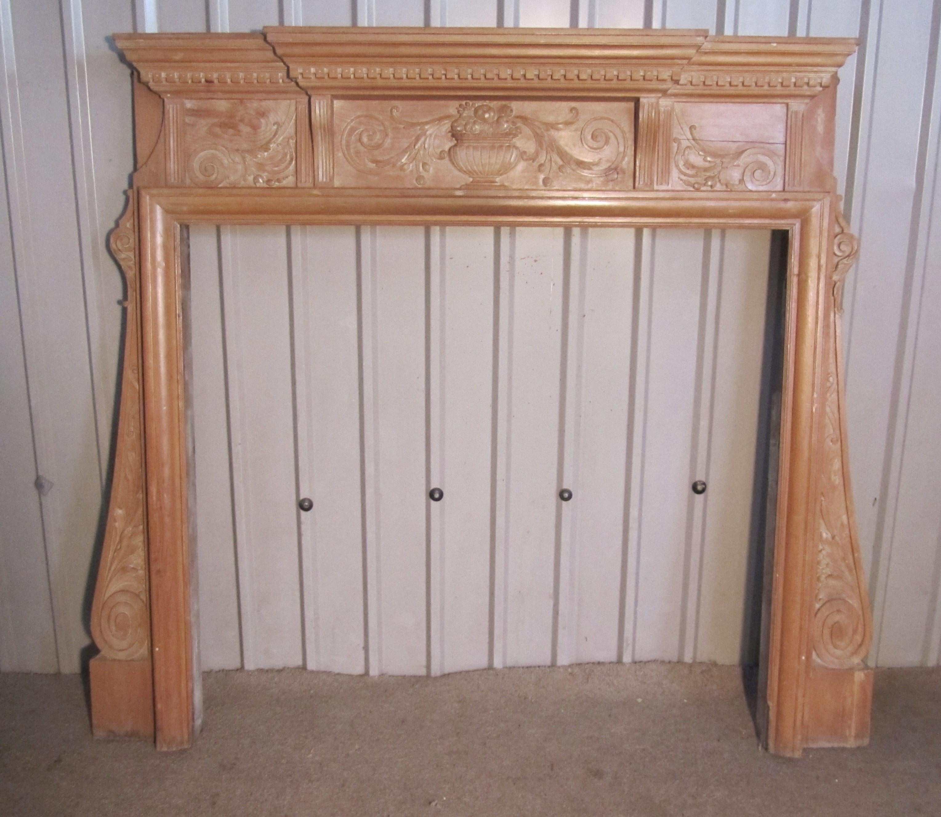 A large decorative victorian pine fireplace.

The Fireplace has a large Break Front mantle piece with dentil moulding beneath, it is supported by acanthus carved uprights and it also has carved urn centrepiece at the front.
The Fireplace has been