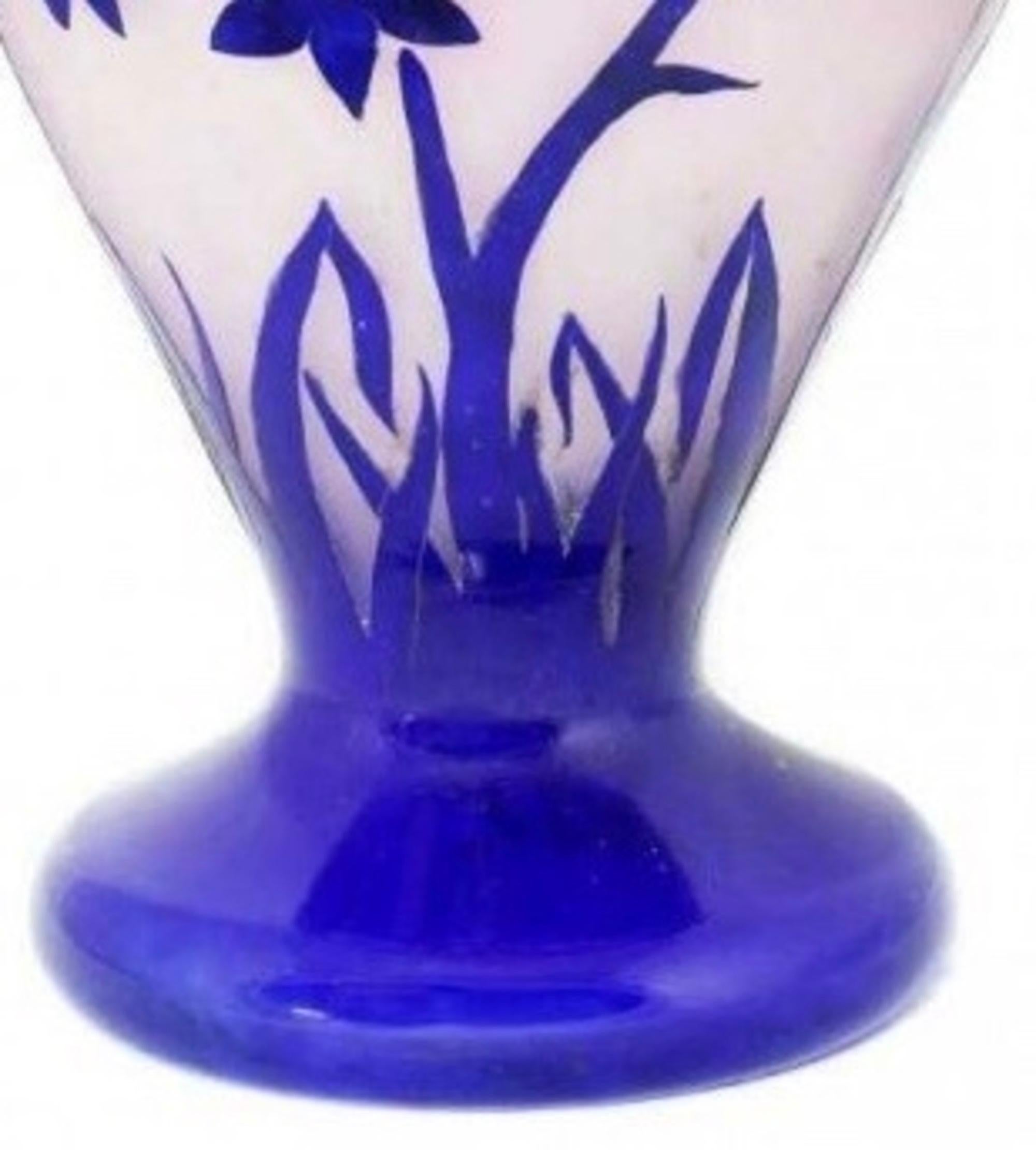 
A large Degué cameo glass vase
France, circa 1930
The mottled purple ground overlaid in red and blue, etched with daisies,
measures: 18 in. (45 cm) high
engraved mark 'Degue'.