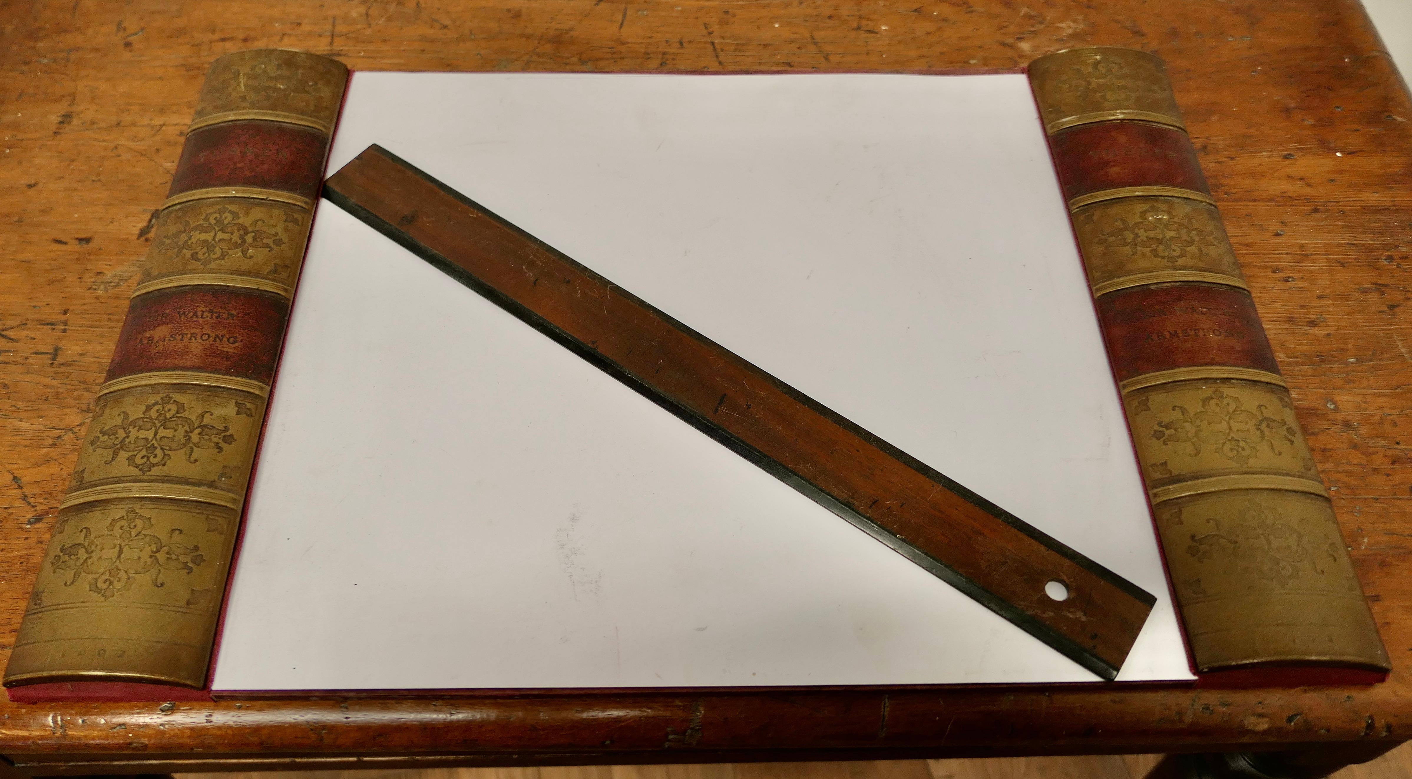 A Large Desk Blotter 

A great piece of desk furniture, the blotter has simulated book spines in gilt and burgundy leather, and it also comes with a Matching Stanley ruler
The Blotter is 15”x 22”
MS265