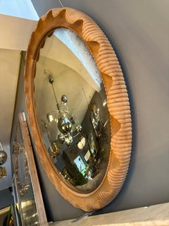 A large Distressed Convex Mirror Within a Carved Oak Frame