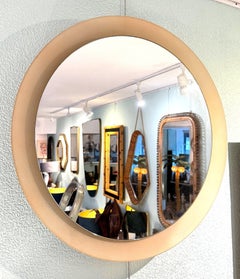 A large dusty pink concave framed circular mirror in the Style of Max Ingrand