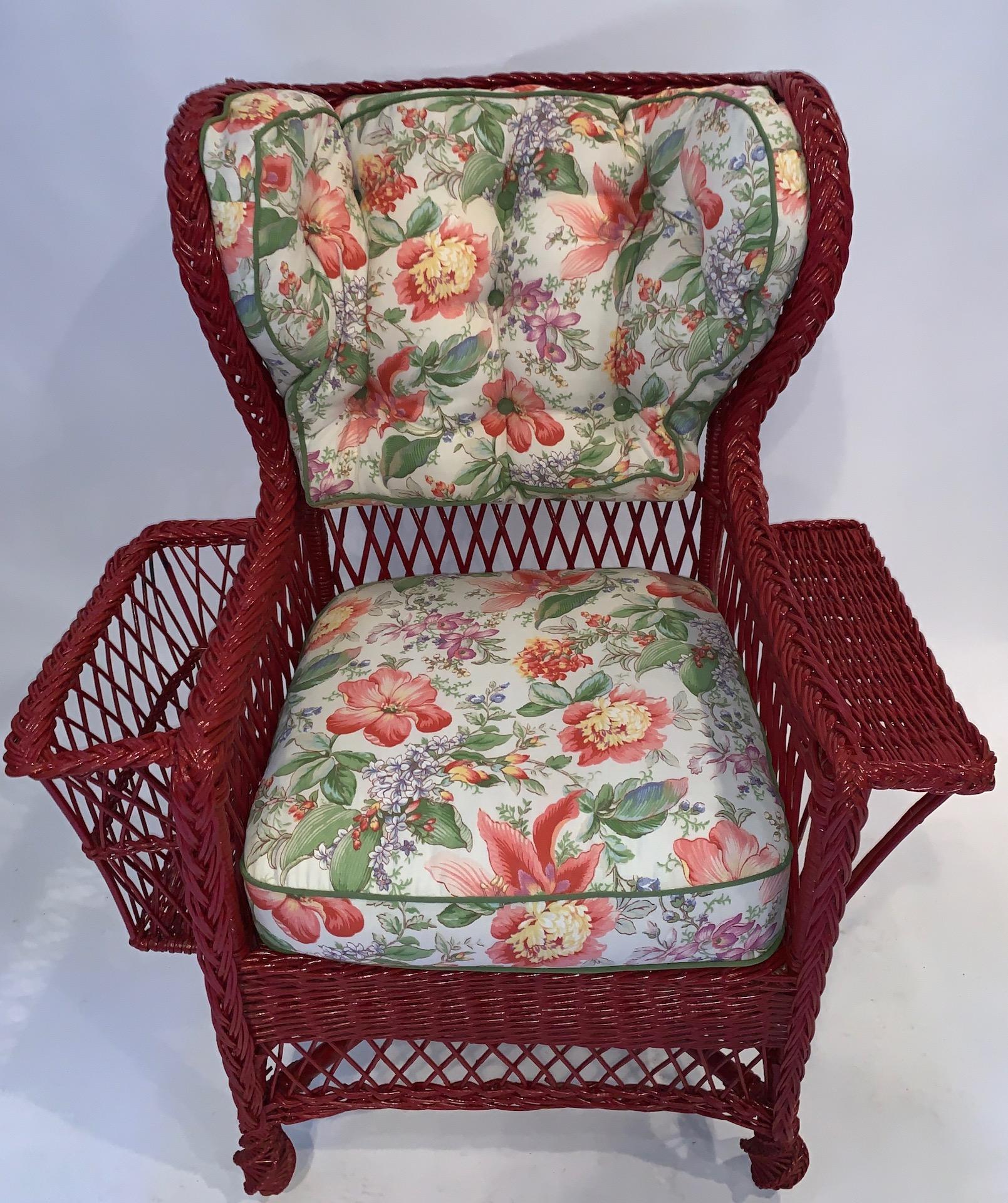 An exceptional large Bar Harbor style wing chair, C. 1900, American with oversized wings, paddle arm and magazine pocket.It is all hand woven including the four intricate pineapple feet. This is one of four complimentary wicker pieces we are