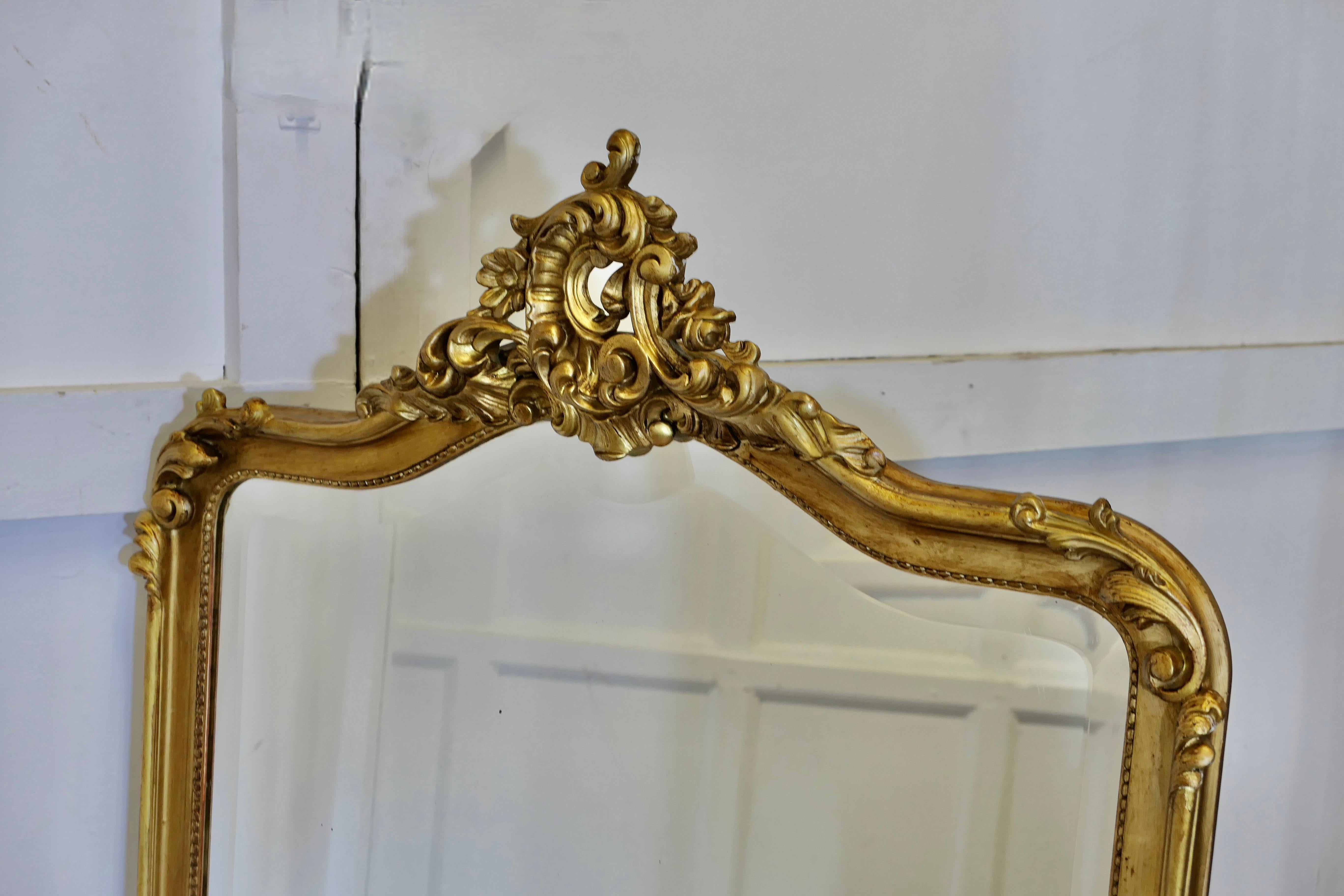 19th Century A Large Elaborate French Rococo Gilt Console Mirror Decorated with Scrolls For Sale