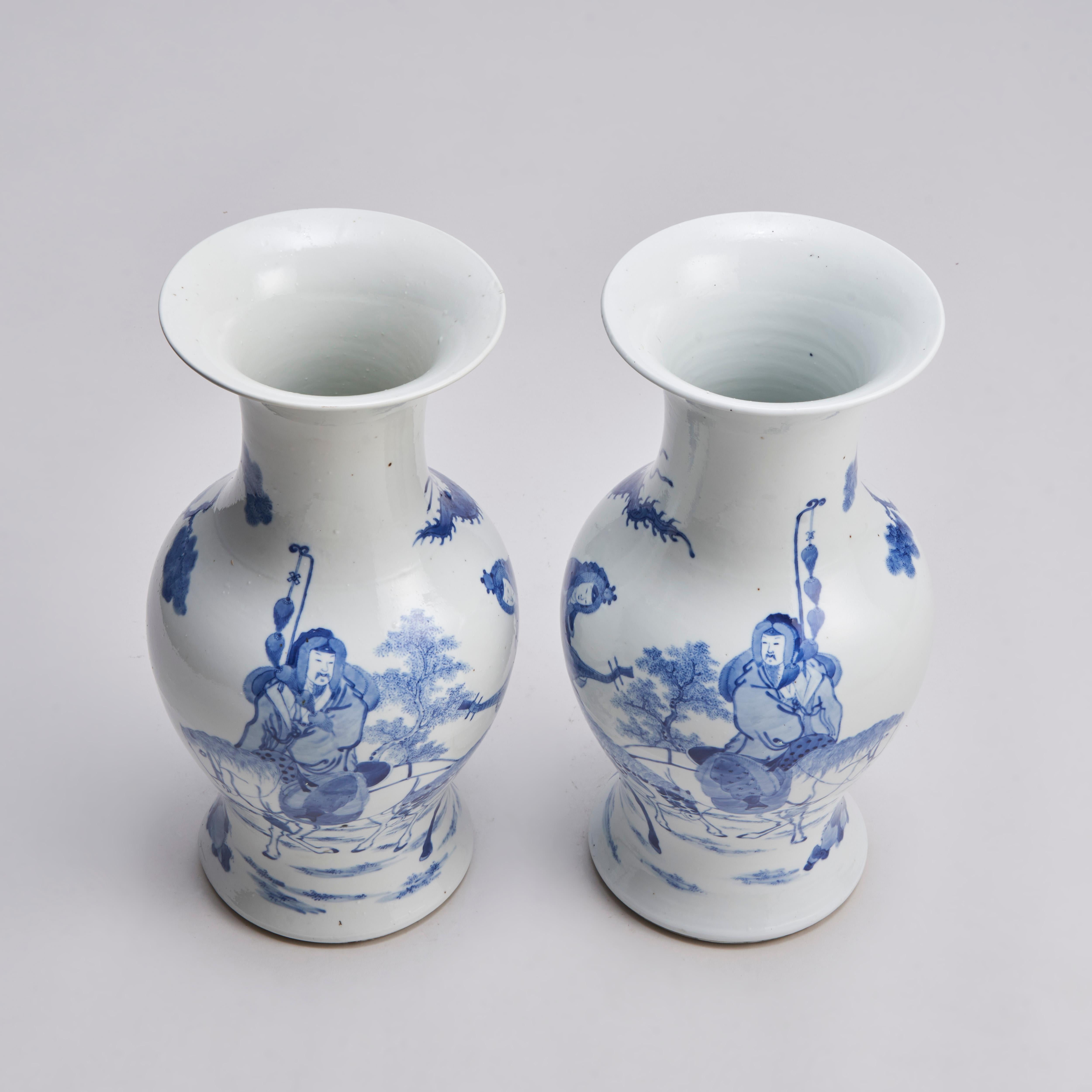A pair of well proportioned 19th century Chinese blue and white Phoenix-tail vases with finely painted mirrored decoration of a sage and a lady on a speckled horse. The lady carries a bBiwa and wears a headdress which suggests that she may be a