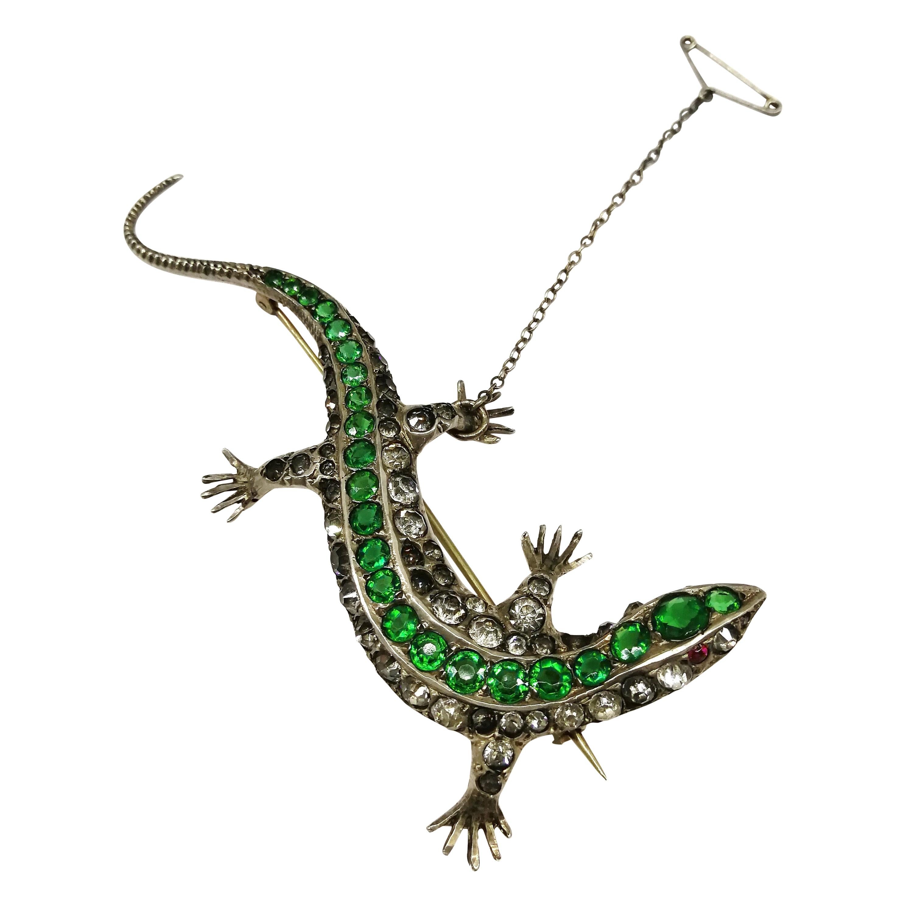 A large emerald and clear paste 'lizard' brooch, c 1900. For Sale