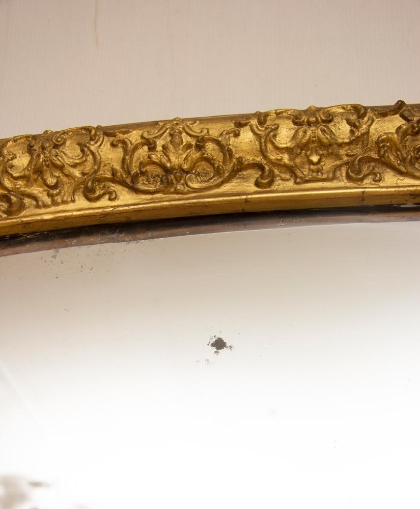 A large English antique gilded overmantel mirror with original mercury glass and backboards.
This can either go above a mantlepiece or just be floor standing.
The glass is quite greyish re reflection with slight overall foxing.
 