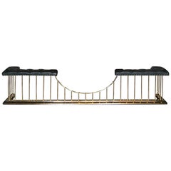 A Large English Brass Fireplace Club Fender