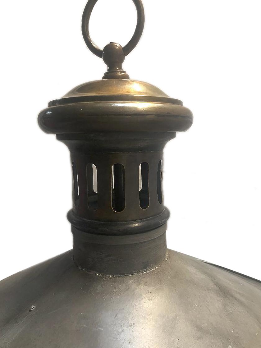 A circa 1950s English hammered metal light fixture with bronze details and a glass lantern inset.

Measurements:
Diameter 31