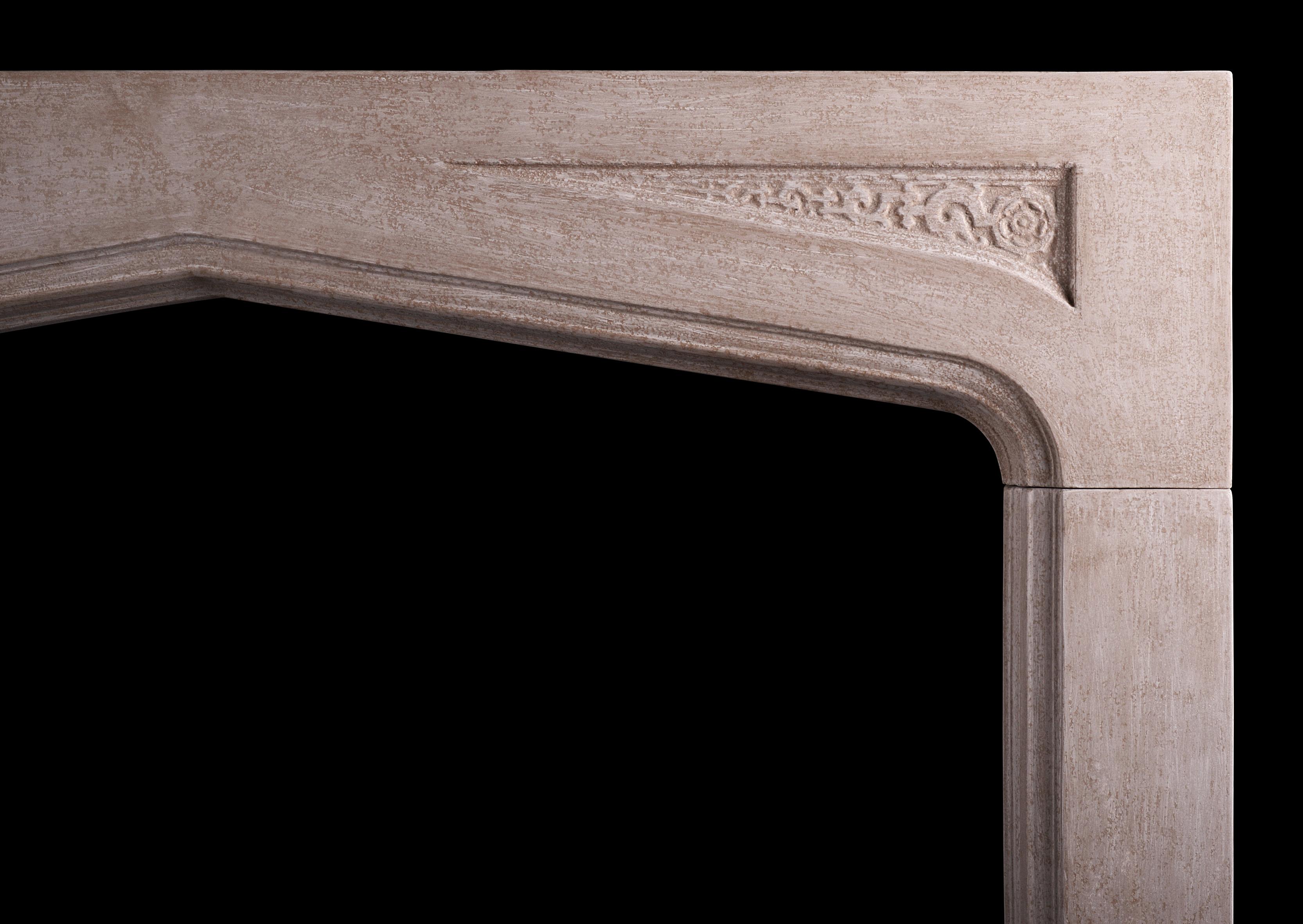 A large English stone fireplace in the Gothic manner. The arched frieze with carved spandrels, the jambs with moulding to inside edge. Finished with a light grey, rustic paint effect. 

Shelf Width: 1731 mm 68 