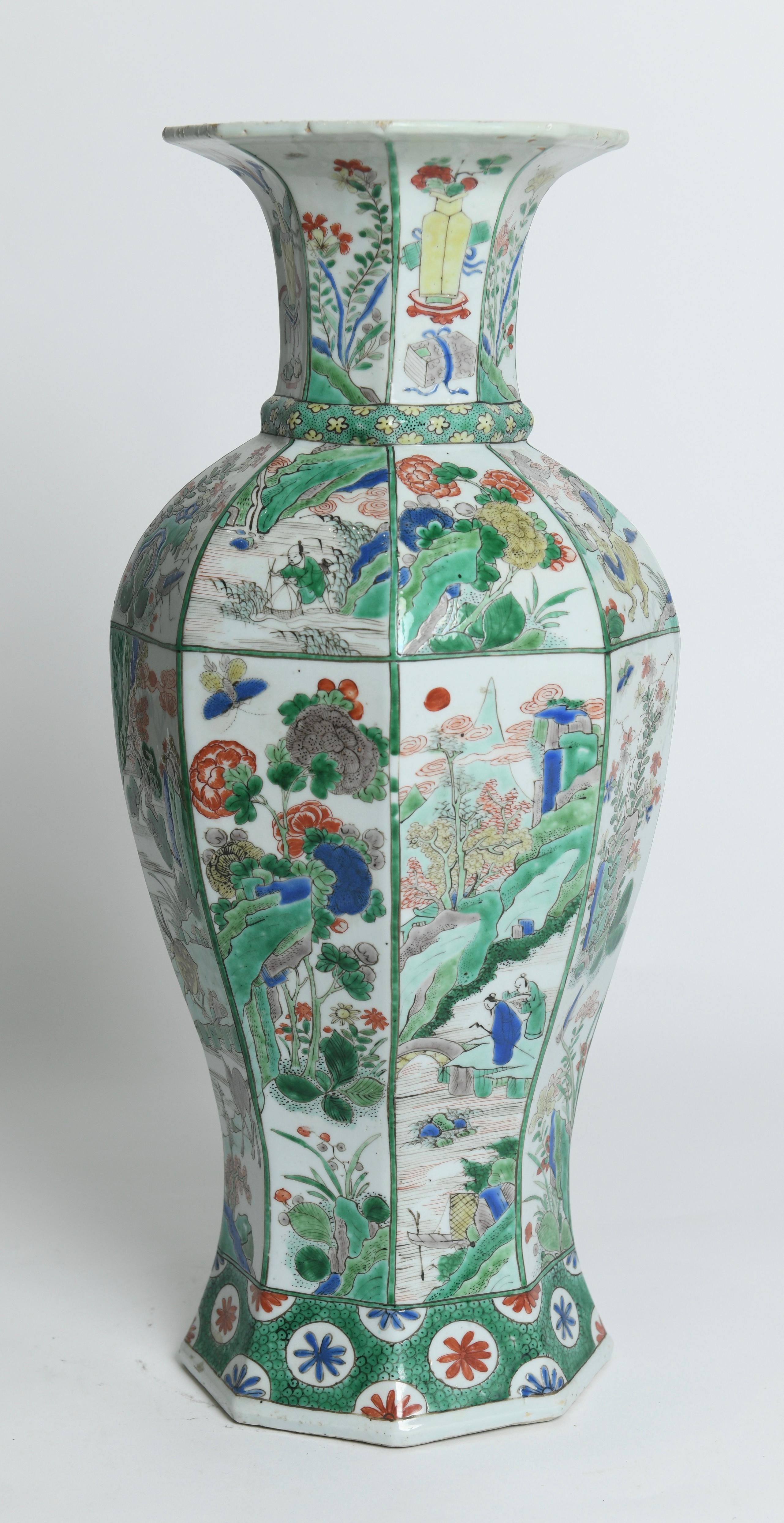 A LARGE FAMILLE VERTE OCTAGONAL BALUSTER VASE China, KANGXI (1662-1722) Of square form with canted corners, sloping shoulder and slightly flaring neck, brightly and boldly enamelled in vibrant tones, with the sides of the body and shoulder variously