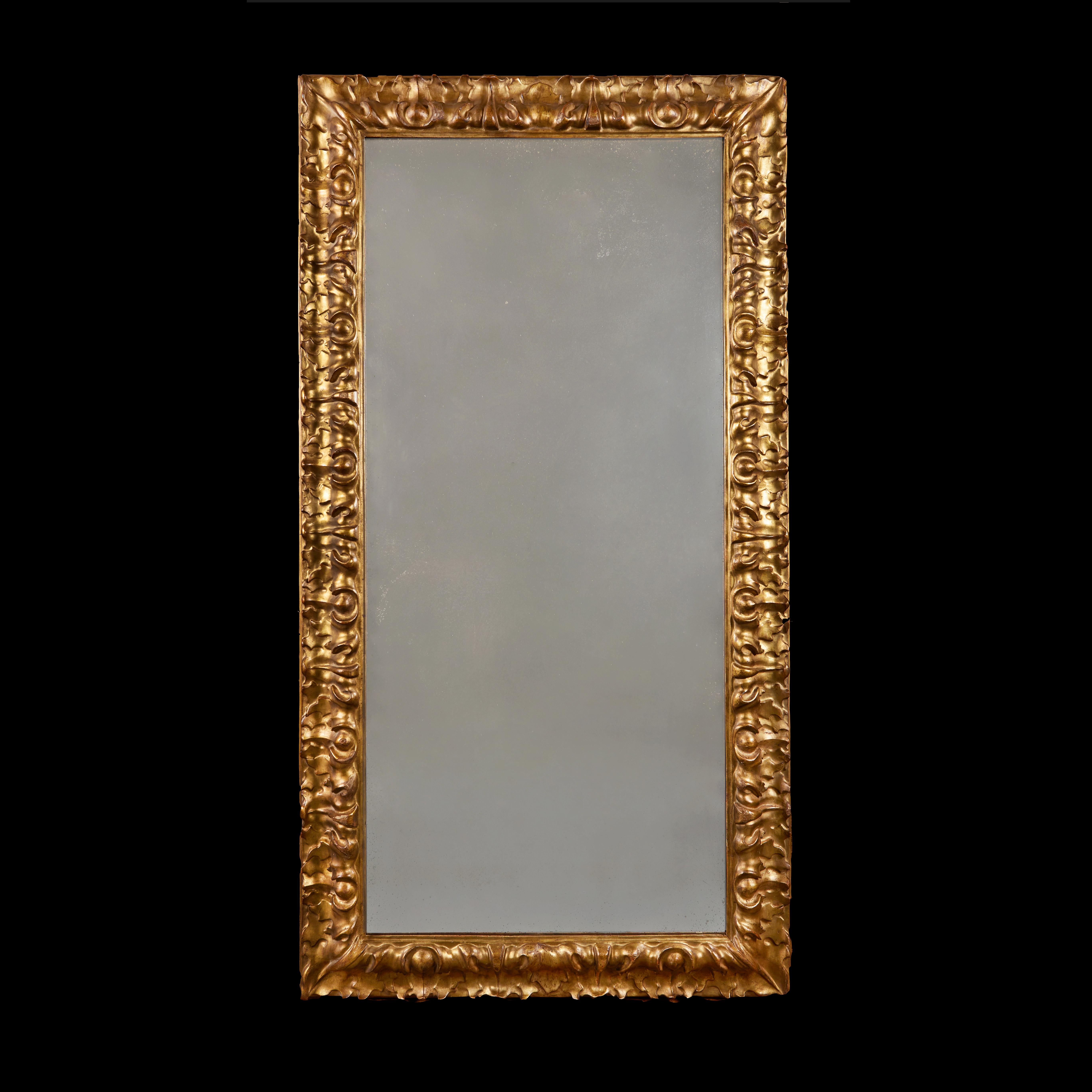 Italie, Florence, vers 1780.

Miroir en bois doré de la fin du XVIIIe siècle, avec une large bordure de motifs feuillus répétitifs profondément sculptés, et une plaque de miroir au mercure.

Hauteur 170,00 cm.
Largeur 91,00 cm.
Profondeur 9,00 cm.