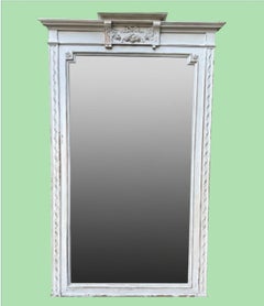 A large French 1880s painted over mantle mirror with original shaped bevel plate