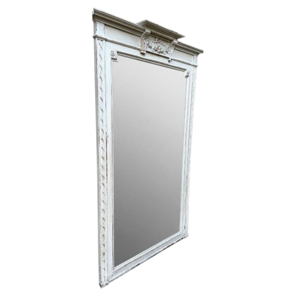 A large French 1880s painted over mantle mirror with original shaped bevel plate