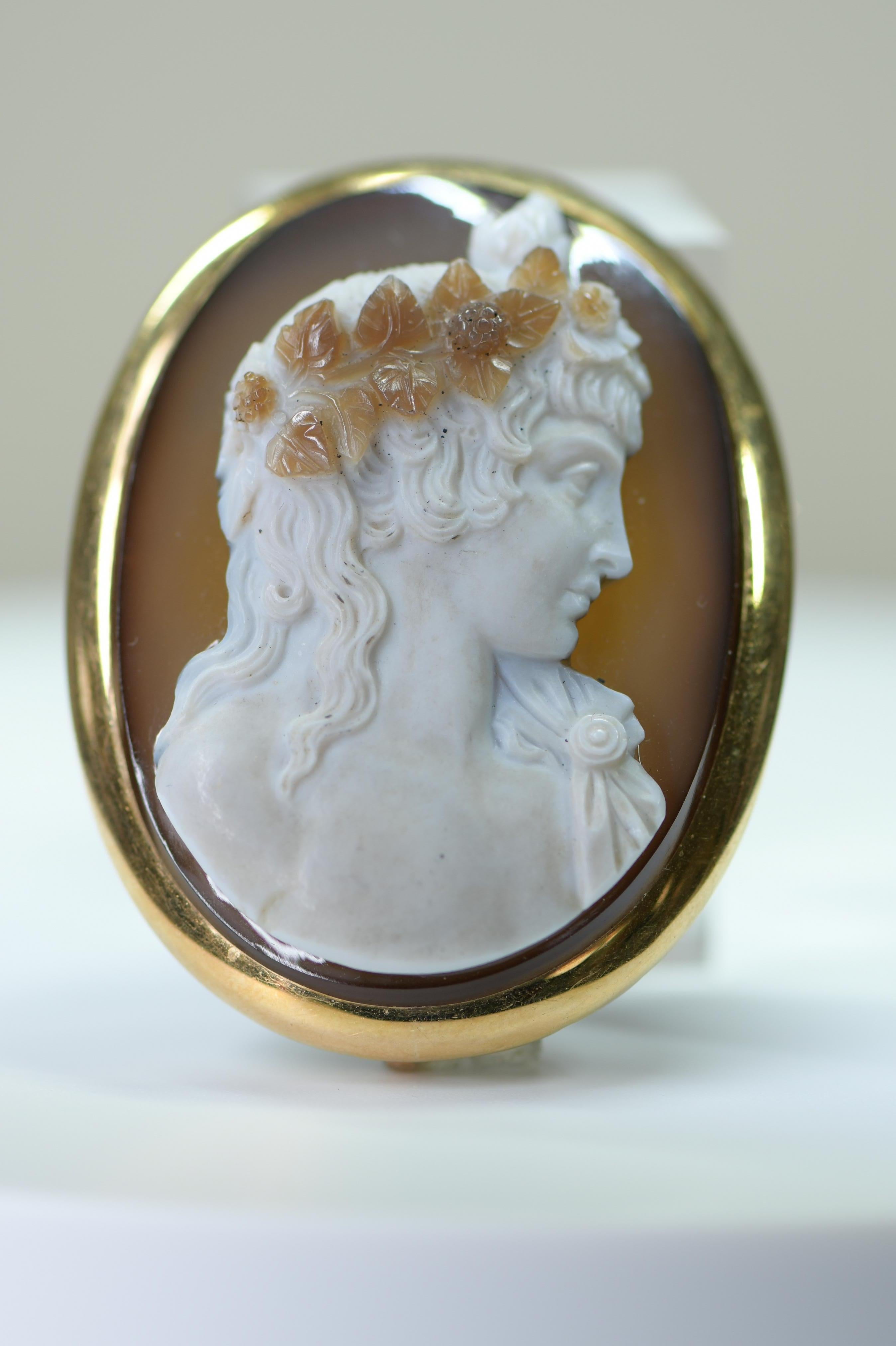 A very fine and large French portrait cameo, circa 1860,  the cameo is very finely carved, with interesting attention to detail in the hair and dress Configured as a brooch or pendant. The mount is at least 18ct gold and compliments the