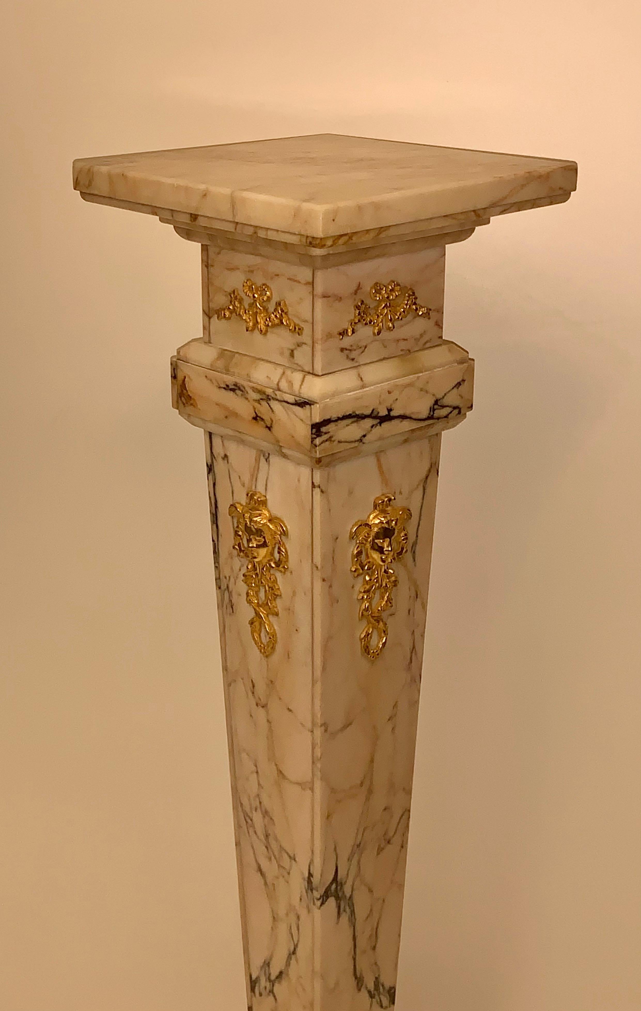 A large French antique gilt bronze mounted marble pedestal
Having a central female gilt bronze mount with a floral wreath under a rotating top with additional bronze mountings an Elegant French Empire style marble pedestal stand. This classical