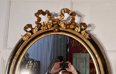 Large French Ebonized and Gilt Oval Wall Mirror