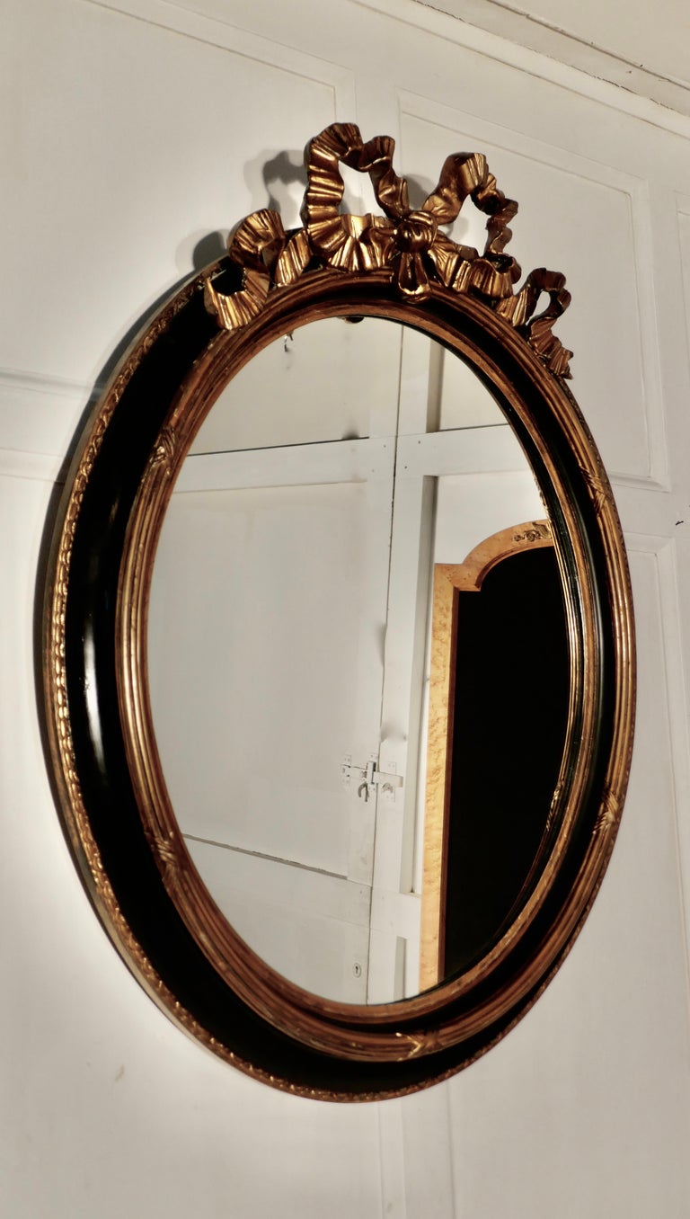 Large French Ebonized and Gilt Oval Wall Mirror For Sale at 1stDibs