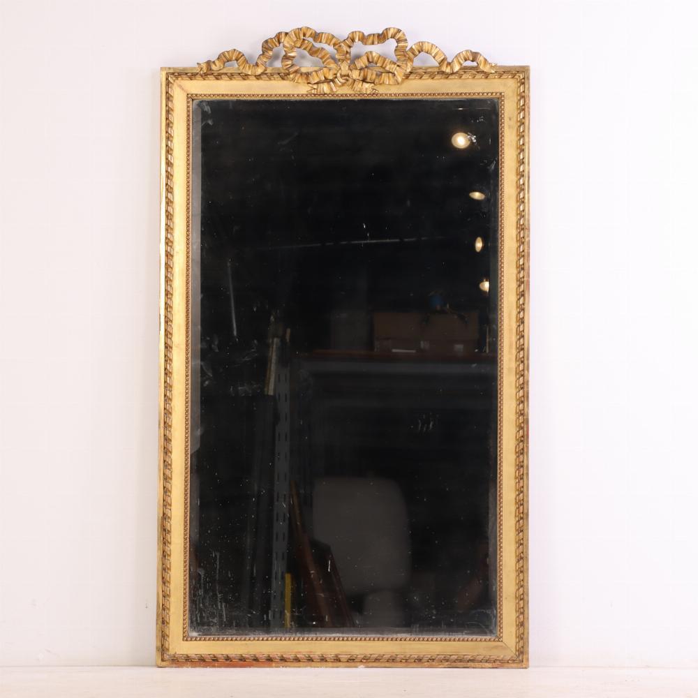 Mirror A large French giltwood mirror with ribbon crest, C. 1890. For Sale