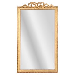 A large French giltwood mirror with ribbon crest, C. 1890.
