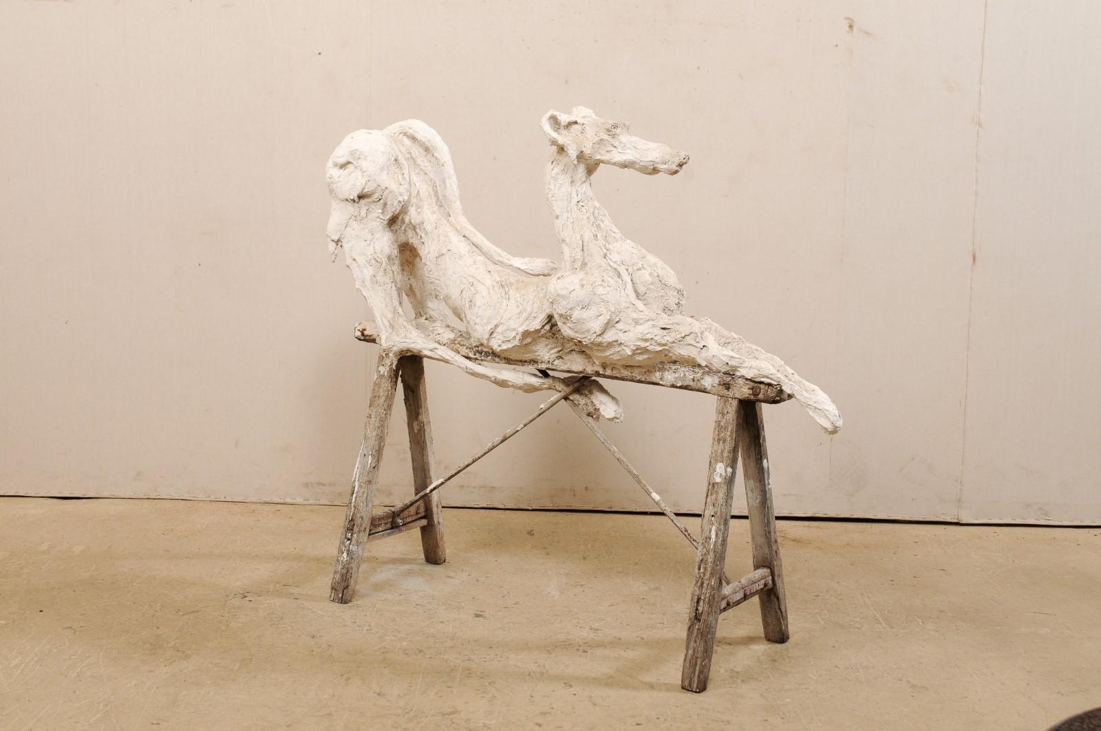 A large-sized French artisan created greyhound dog sculpture. This fabulous statue from France has been created in the image of a regal Greyhound dog, in alert laying position with head facing forward, front legs stretched out far in front, and
