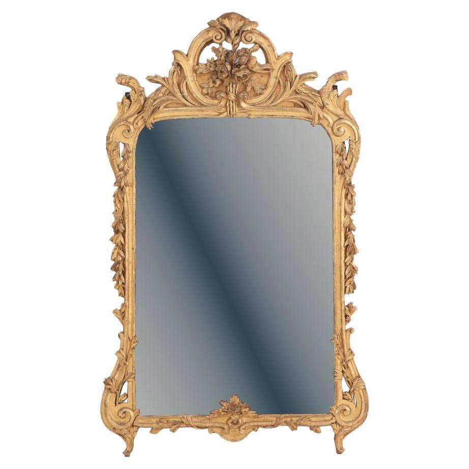 A large French Louis XV style carved giltwood mirror, 18th C.