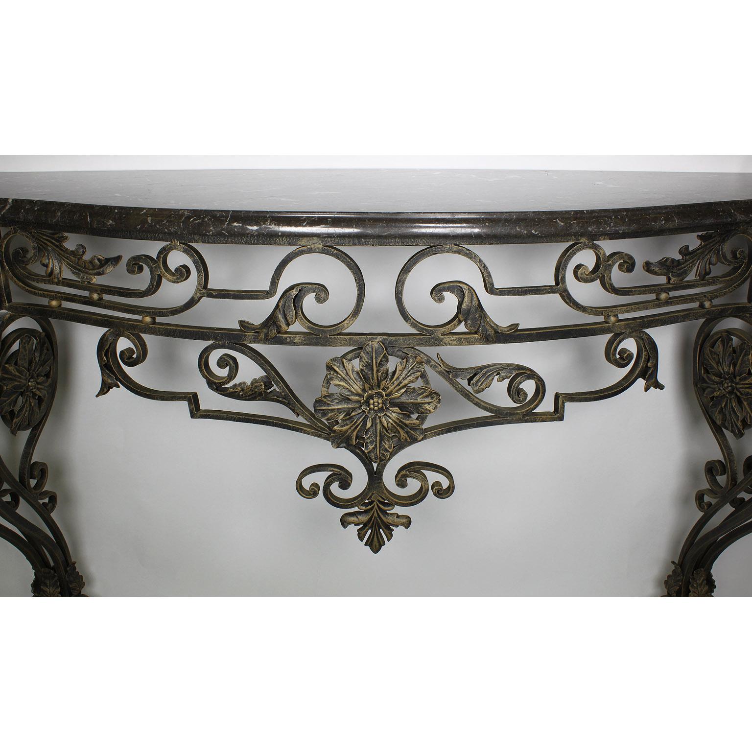 A Large French Louis XV Style Wrought Iron Wall Mounting Console with Marble Top. The ornately scrolled iron frame surmounted with floral decorations and fitted with a veined grey marble top. Circa: 20th Century

Height: 39 3/4 inches (101