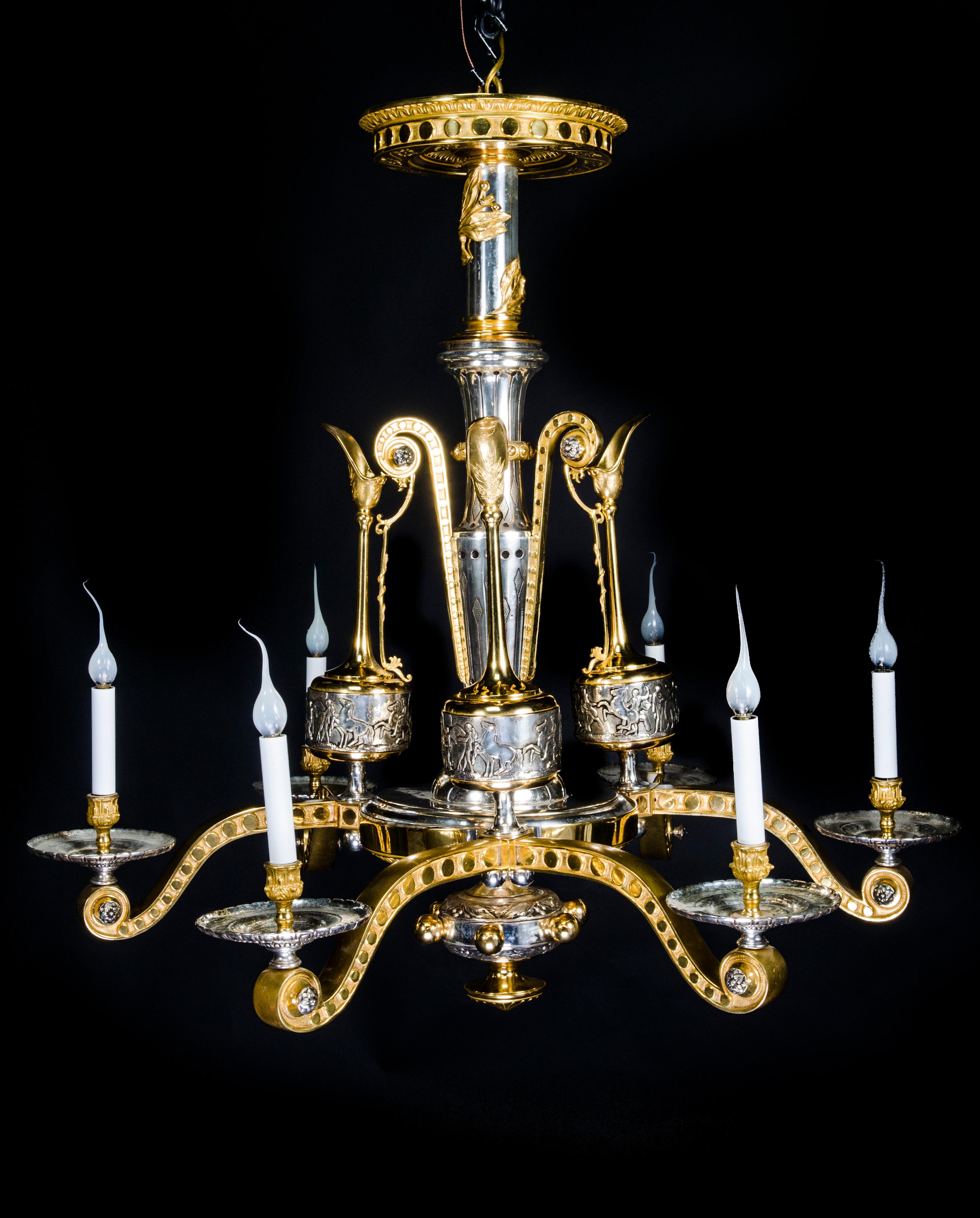 A spectacular and rare large Antique French Neoclassical gilt bronze and silvered bronze multi arm chandelier of exquisite craftsmanship attributed to F. Barbedienne. This extremely unique and large chandelier is embellished with three large
