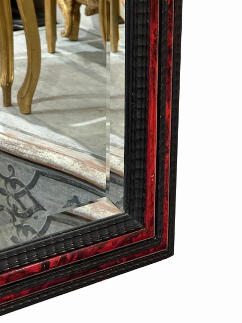 This modern ebonized mirror is reflective of the 19th century Flemish style cushion mirrors. The ripple carving gives additional movement and depth to the frame. A wonderful addition to a powder or dressing room.
