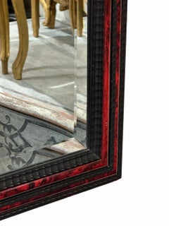 A large French ripple carved and faux tortoiseshell cushion mirror.