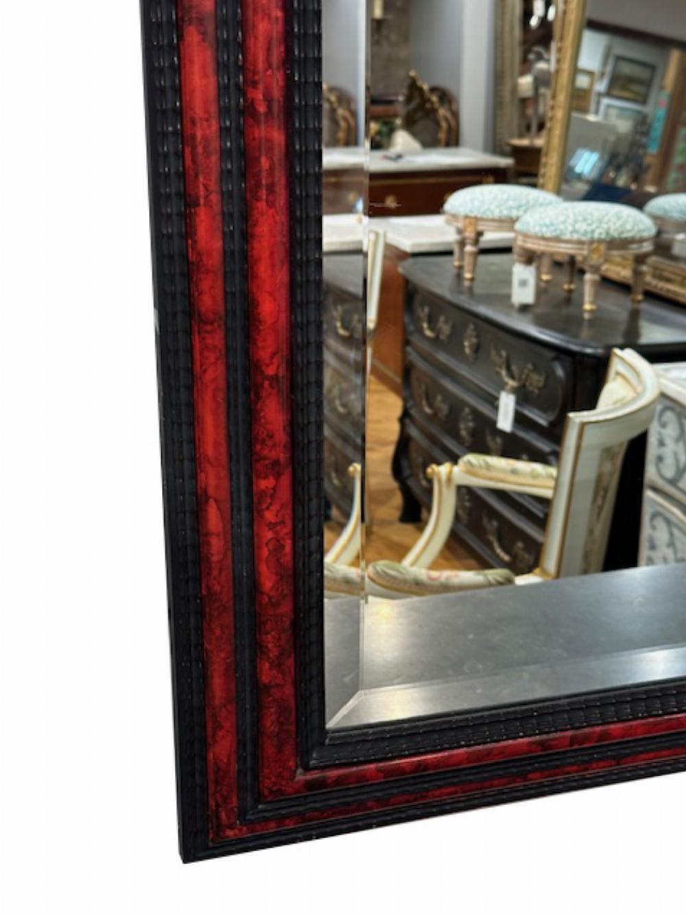 A large French ripple carved and faux tortoiseshell cushion mirror. In Good Condition For Sale In Philadelphia, PA