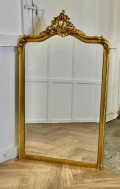 A Large French Rococo Gilt Console Mirror Decorated with Leaves and Scrolls