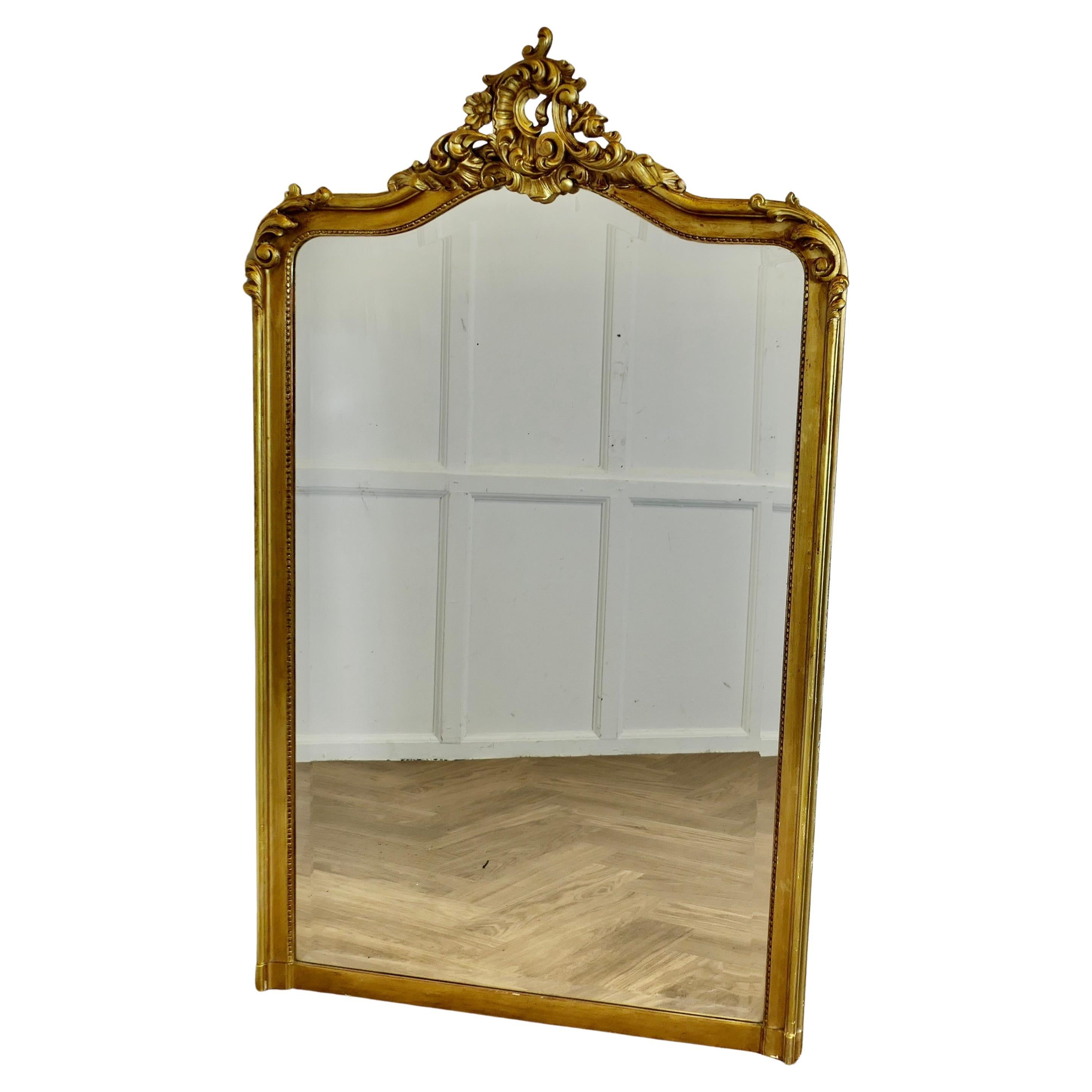 A Large French Rococo Gilt Console Mirror Decorated with Leaves and Scrolls For Sale