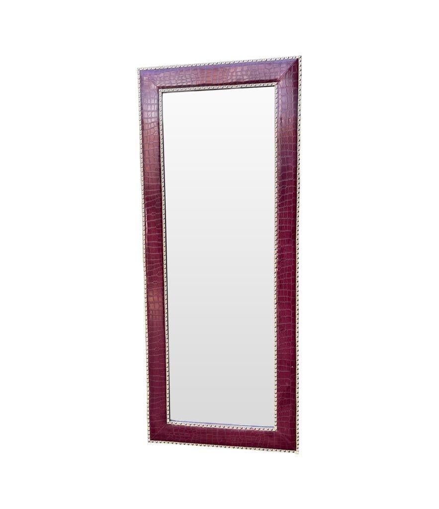Hollywood Regency A large full length mirror with burgundy faux crocodile skin frame. For Sale