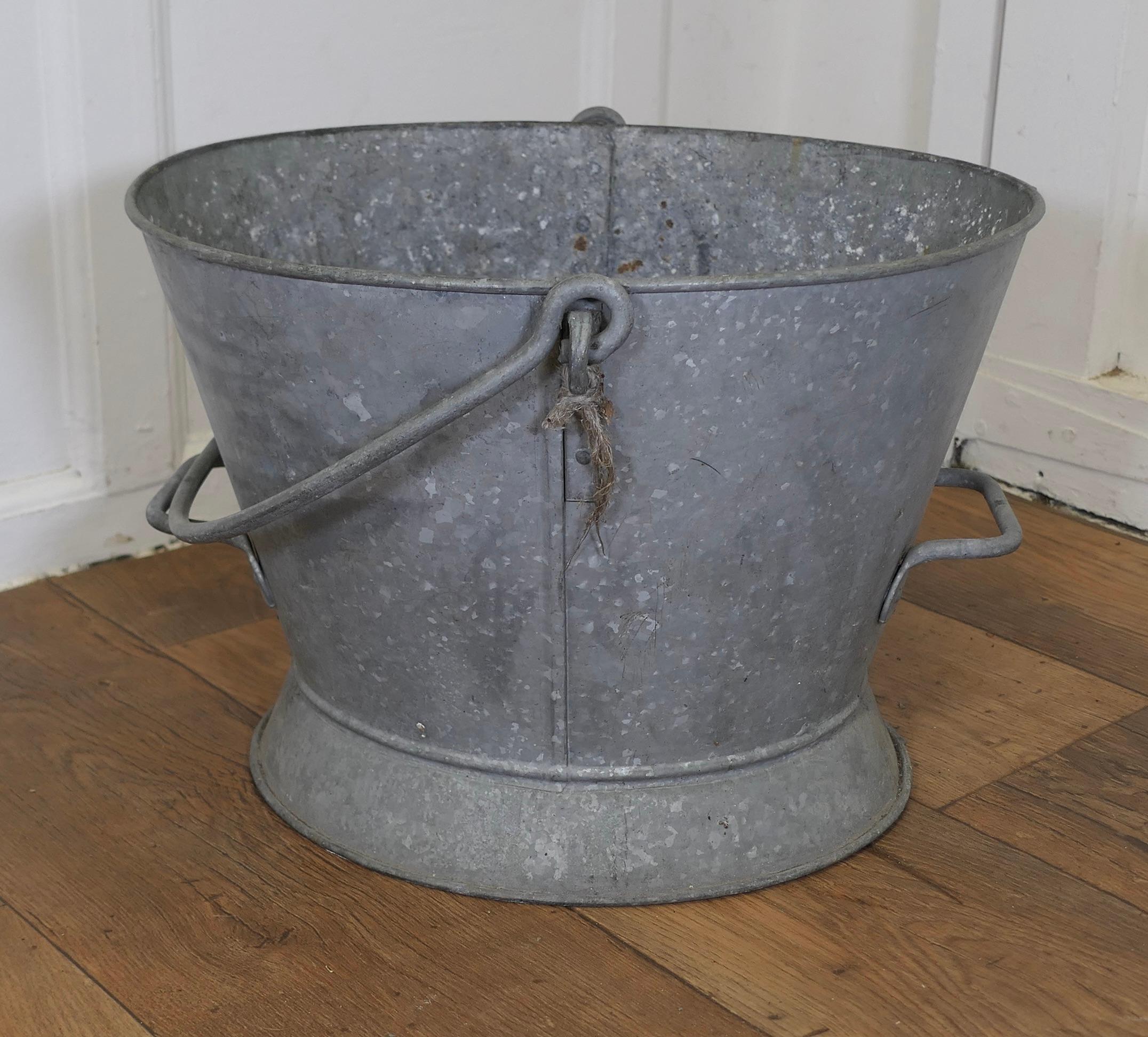 A Large Galvanised Housemaid’s Bucket

A Traditional piece and a very versatile and strong piece, the housemaid would have carried this one by the swing handle and used the end handles for pouring or emptying the bucket
A large piece and in good