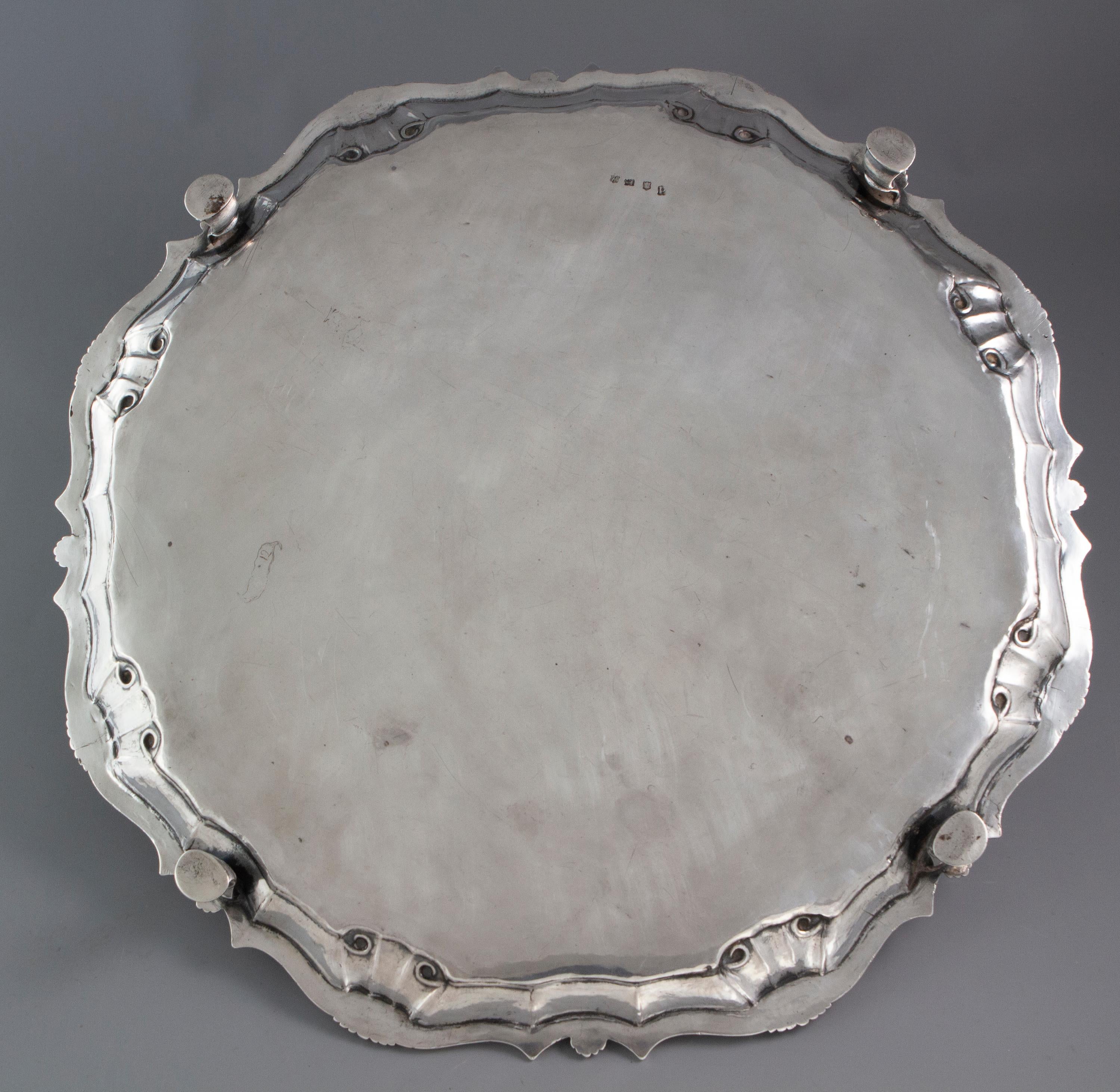A very fine George II silver salver or tray of large shaped circular form. A cast and applied shell and scroll gallery, with the plain central plate engraved with a vacant rocaille cartouche. The whole standing on four hoof feet.

Clearly