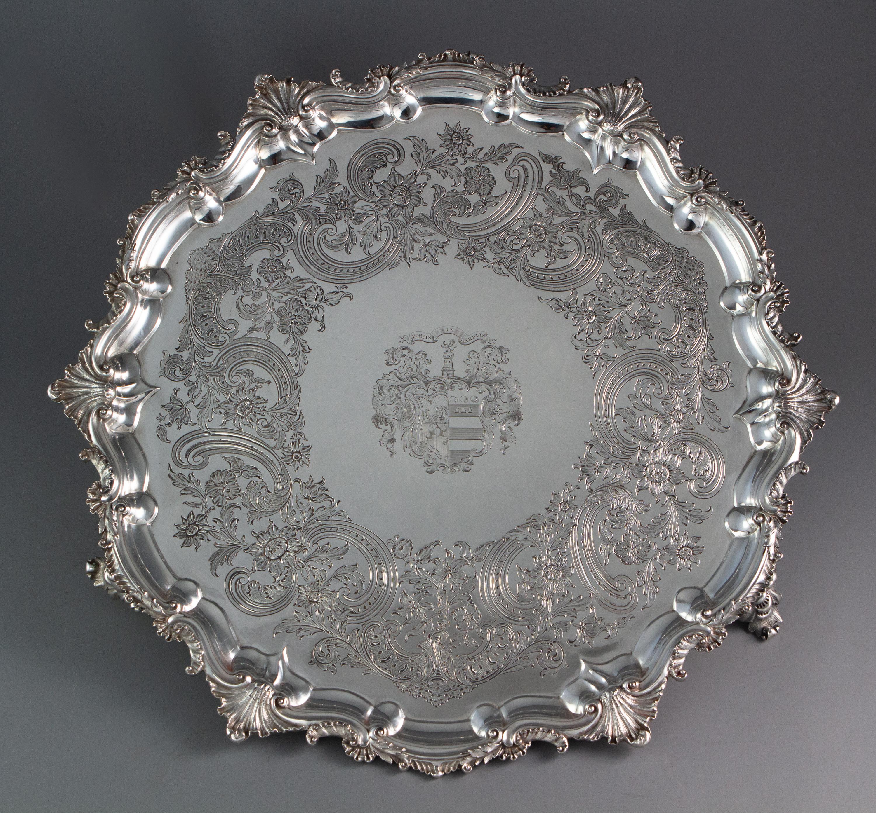 A very large and impressive Georgian silver salver by Paul Storr, London 1829. Of circular form with an ornately cast border, decorated with shells and acanthus motifs. Superbly engraved to the plate with a floral and foliate design, all standing on