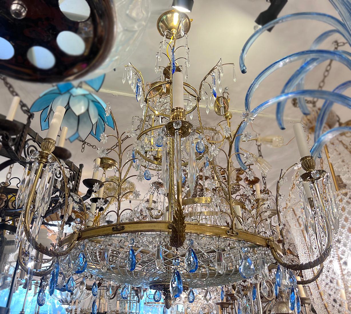 A circa 1900's gilt bronze Baltic chandelier with 8 candelabra lights with Clear and Blue crystal pendants and cut glass body inset.

Measurements: 
Diameter: 40