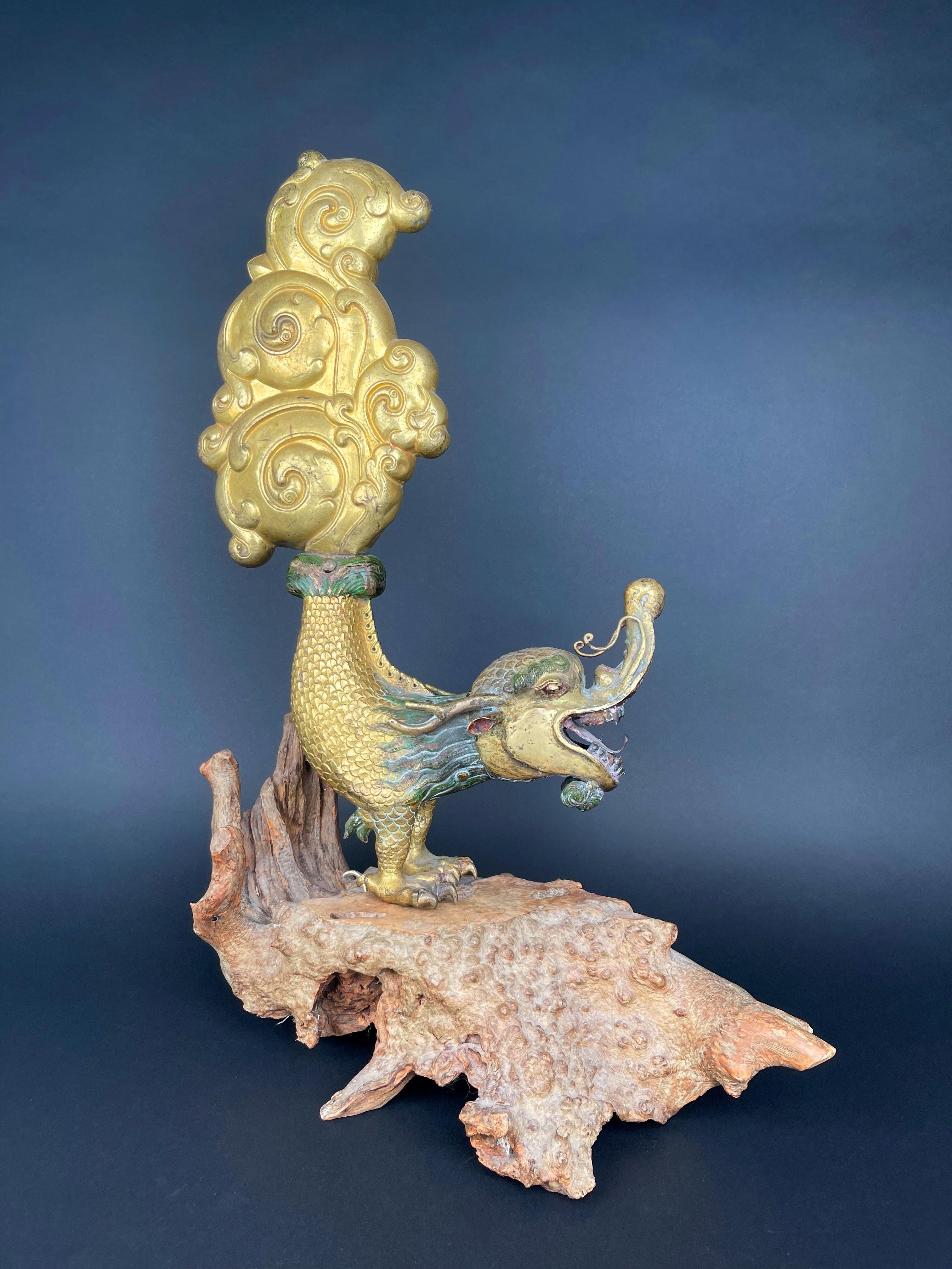 A Large Gilt Bronze Makara Finials, The mythical creature with crocodile body elaborately cast with gaping mouth and coiled trunk, its tail rising up in a finely detailed with rich gilding mounted on piece of wood.

 Tibet, Late 17th Early 18th