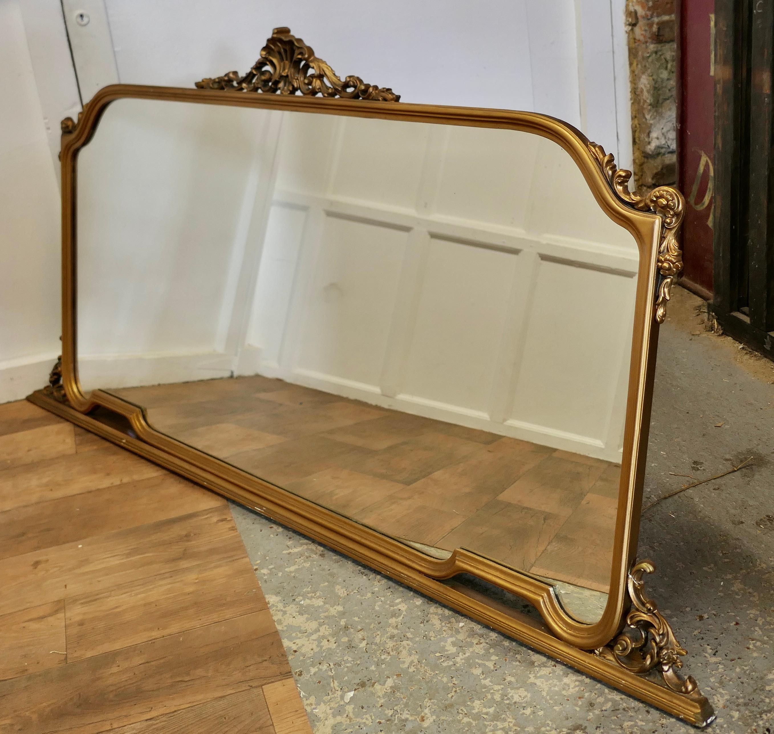 A Large Gilt Over Mantle Mirror  

This Mirror has a beautiful Gold Frame it is decorated with swags on the top and around the edges
 The large frame is in good sound condition, the looking glass too is in excellent condition
This is a charming