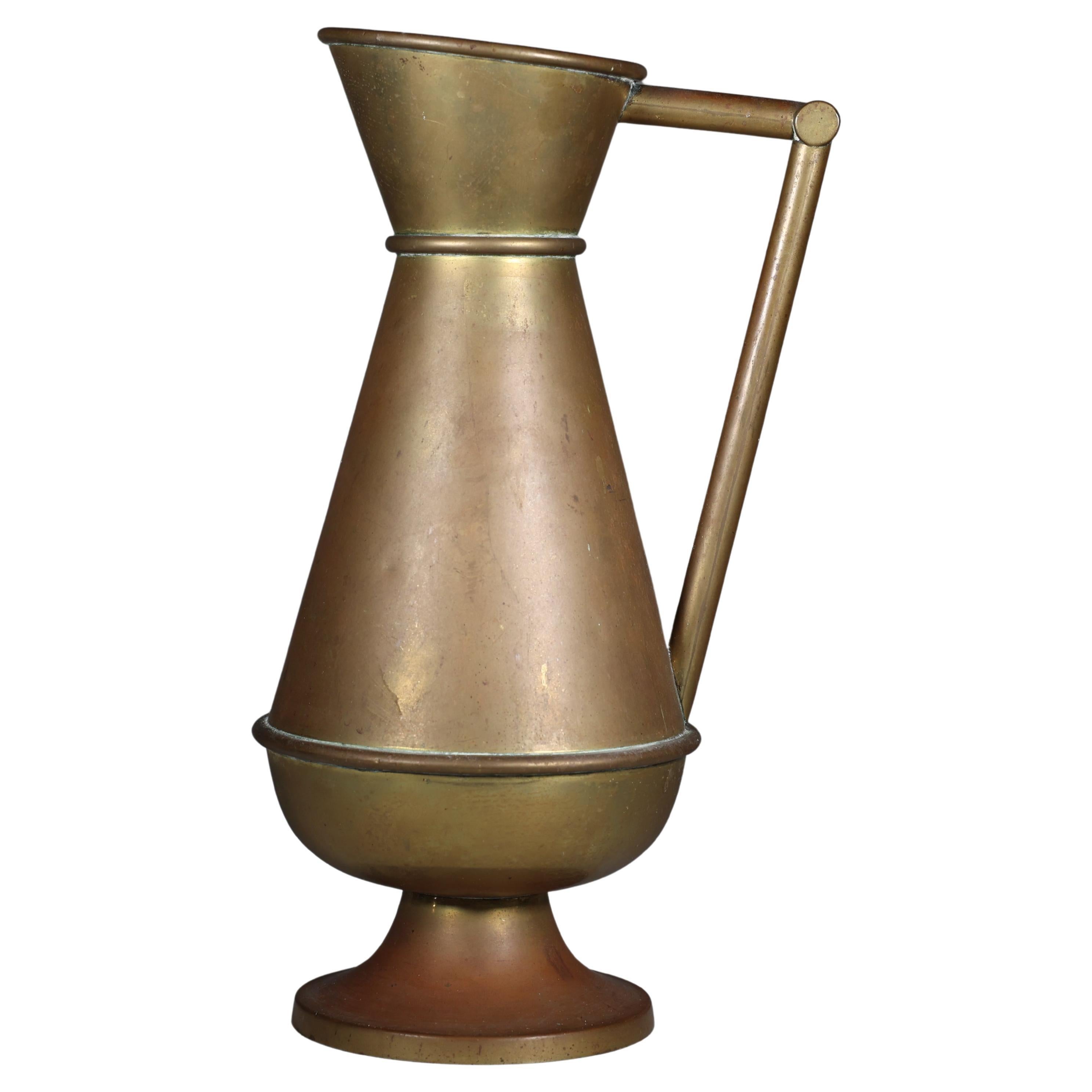 A large Gothic Revival heavy brass jug with a simple angular form and handle. For Sale